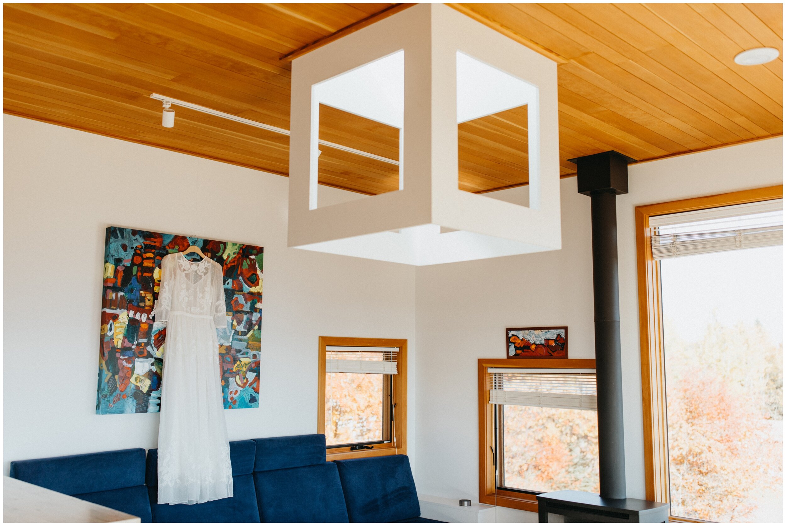 Modern, minimalistic wedding dress hanging in Scandinavian vrbo in Grand Marais, Minnesota