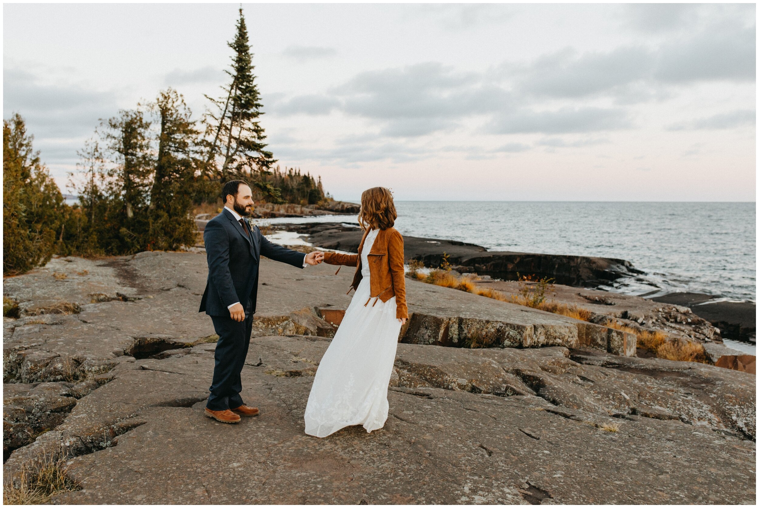 Bride and groom dance on Artists' Point after wedding in Grand Marais, Minnesota