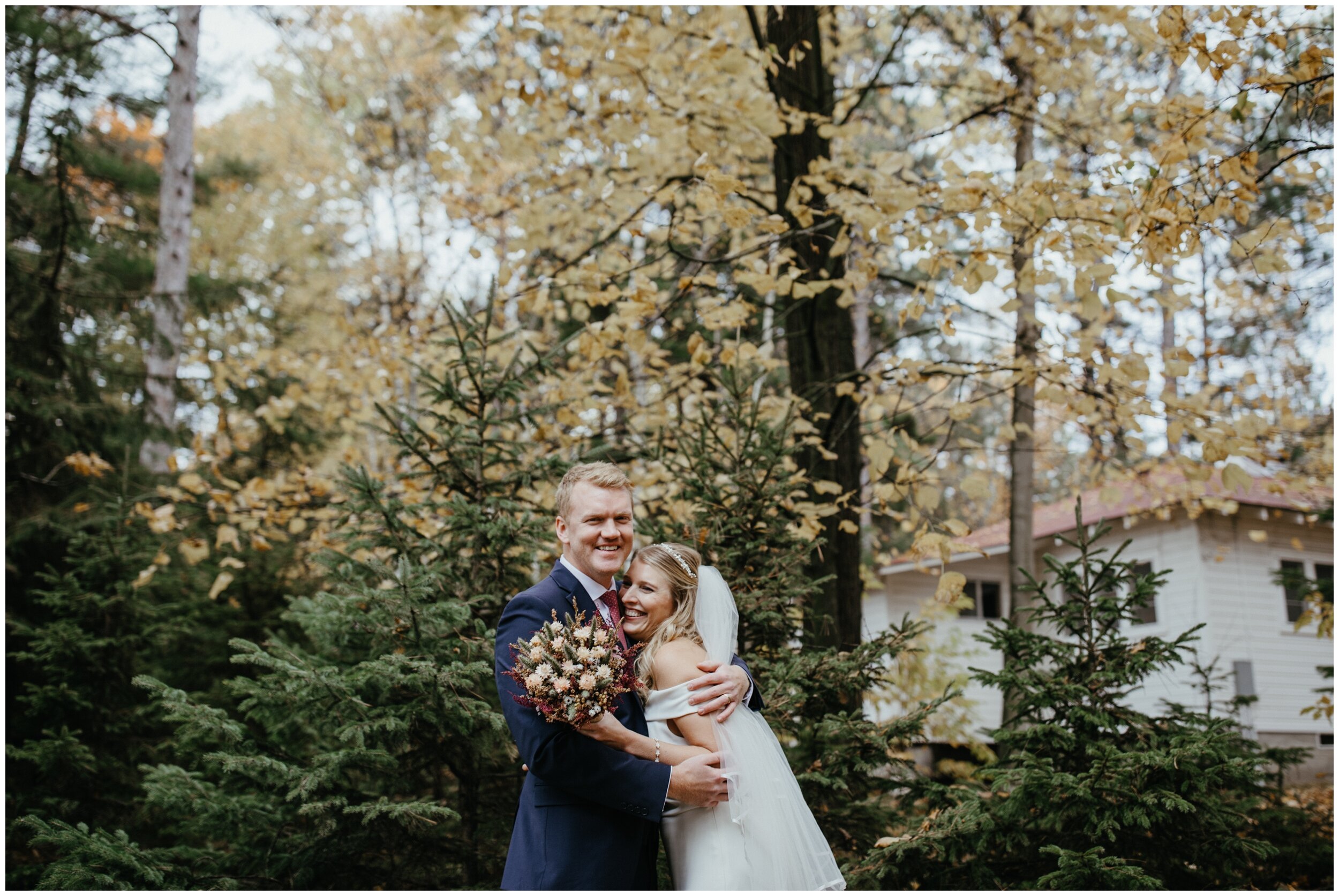 Bride and groom hugging and smiling after getting married at Camp Foley in Crosslake, Minnesota