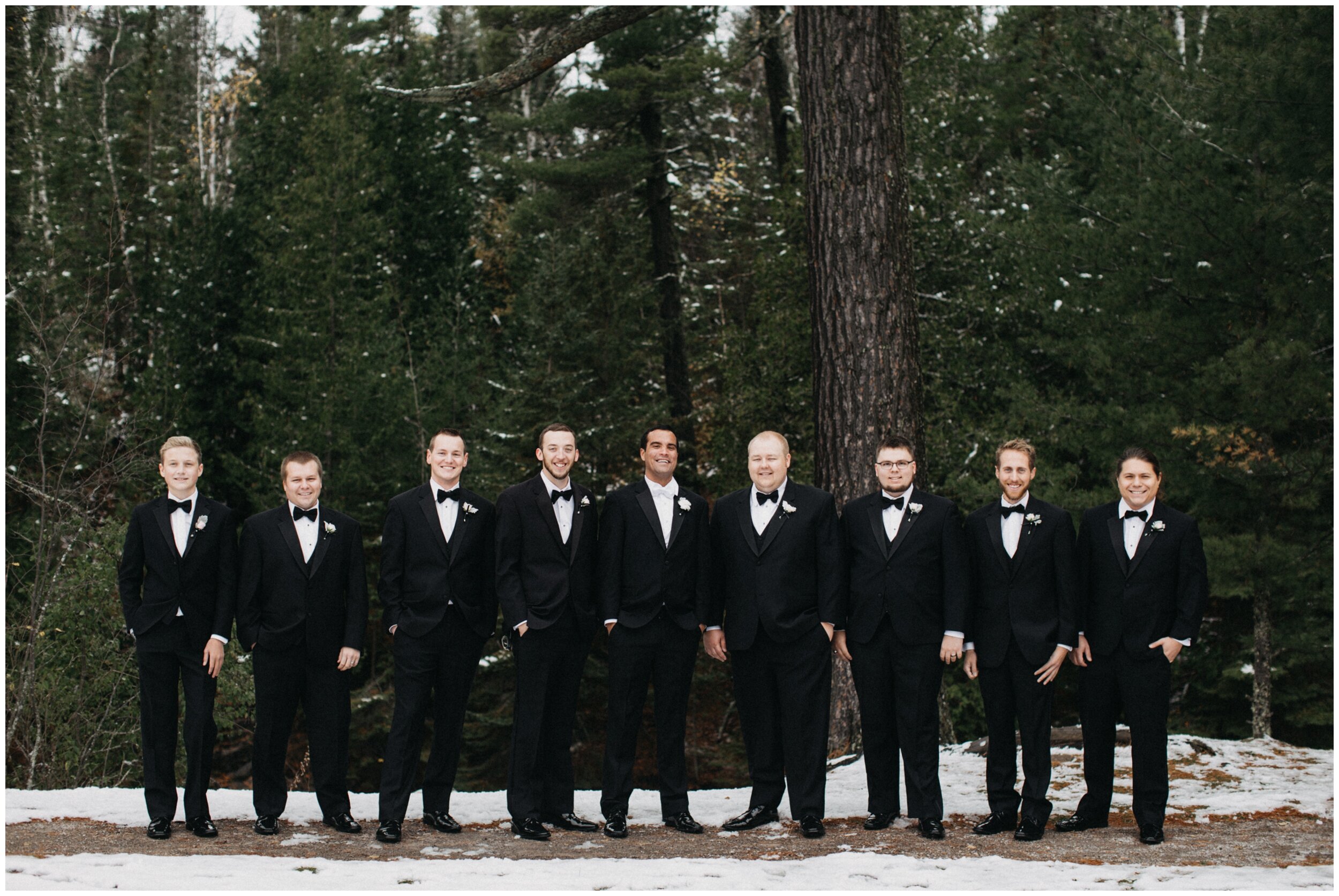 Groom and groomsmen wearing classy black tie tuxedos in Lester Park