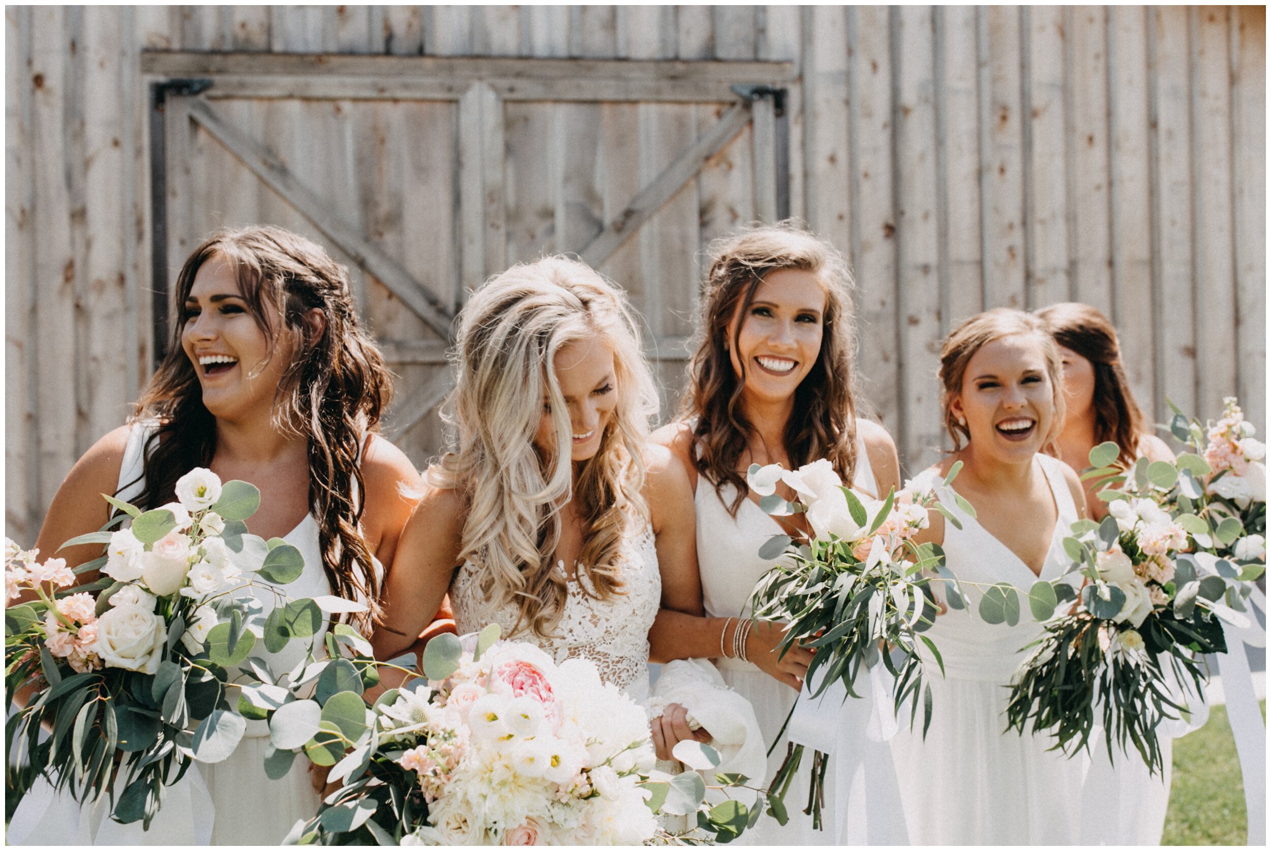 Bride laughing with  brides maids at modern barn wedding at Creekside Farm in Rush City, Minnesota