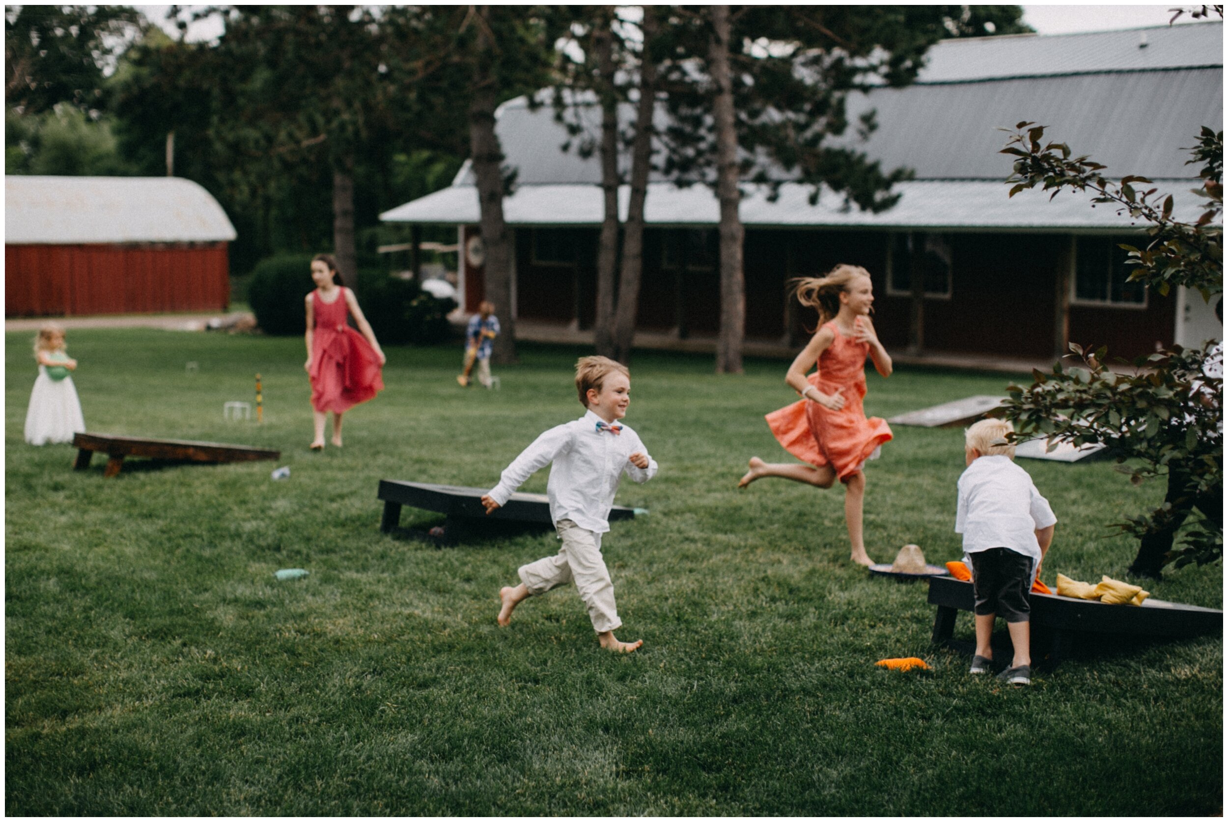 Kids running at outdoor wedding reception