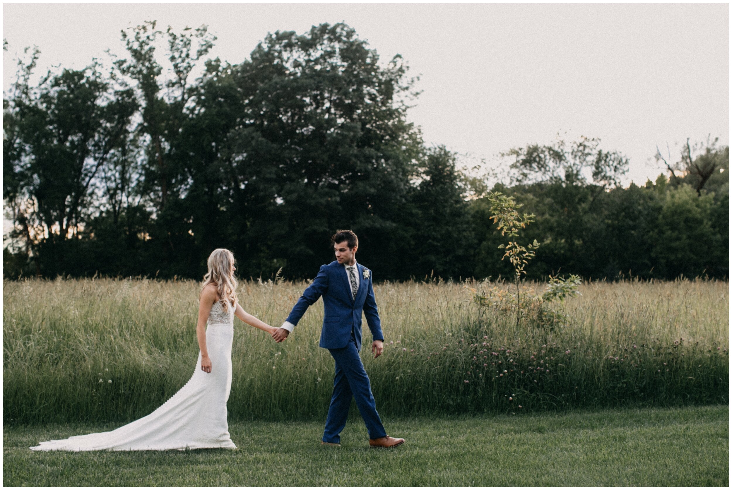 Bride and groom walking on Minnesota farm