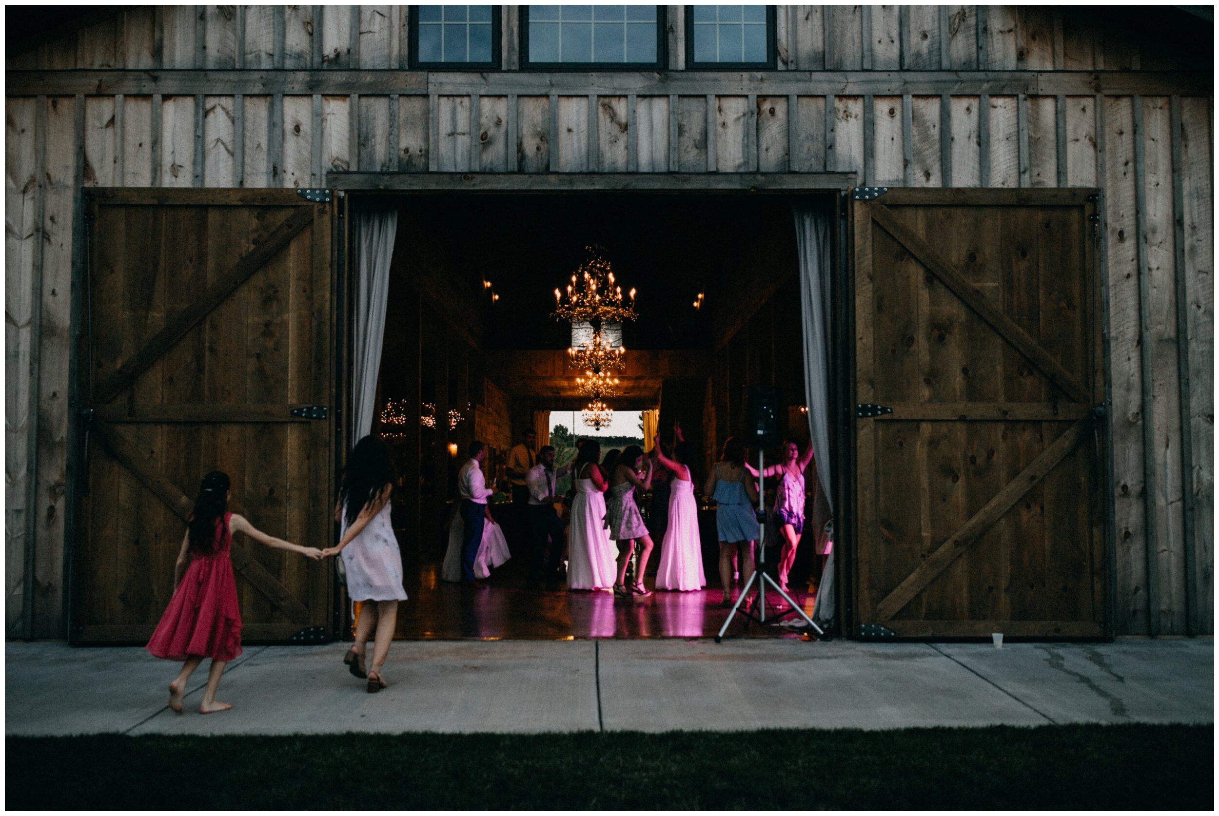 Wedding guests dancing outside barn at Creekside Farm