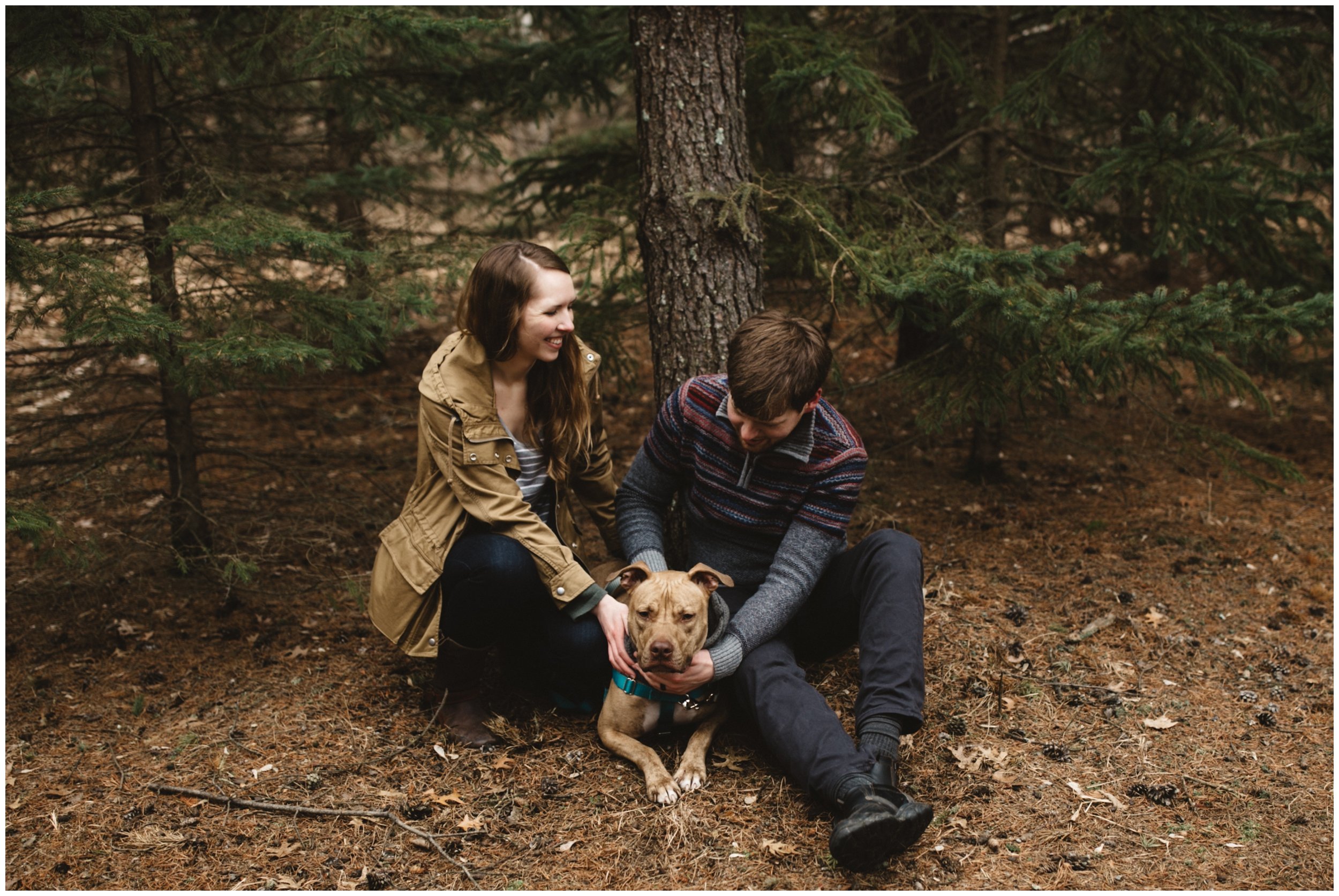 Couple and their dog in the woods during engagement session in Brainerd, Minnesota