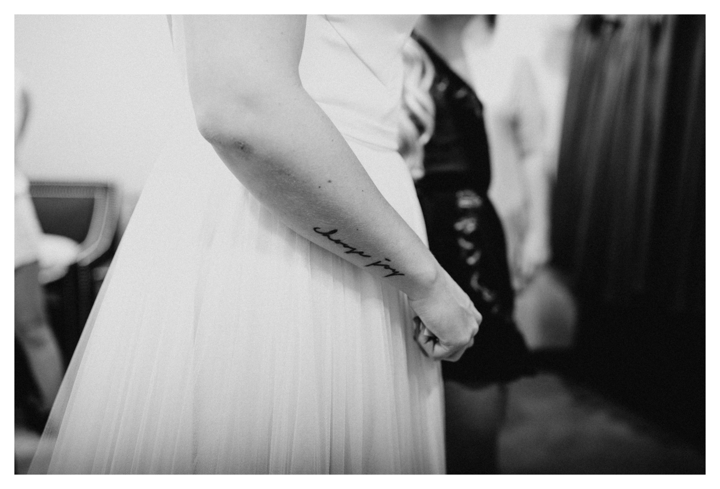 Bride with arm tattoo in wedding dress at 7 Vines vineyard wedding