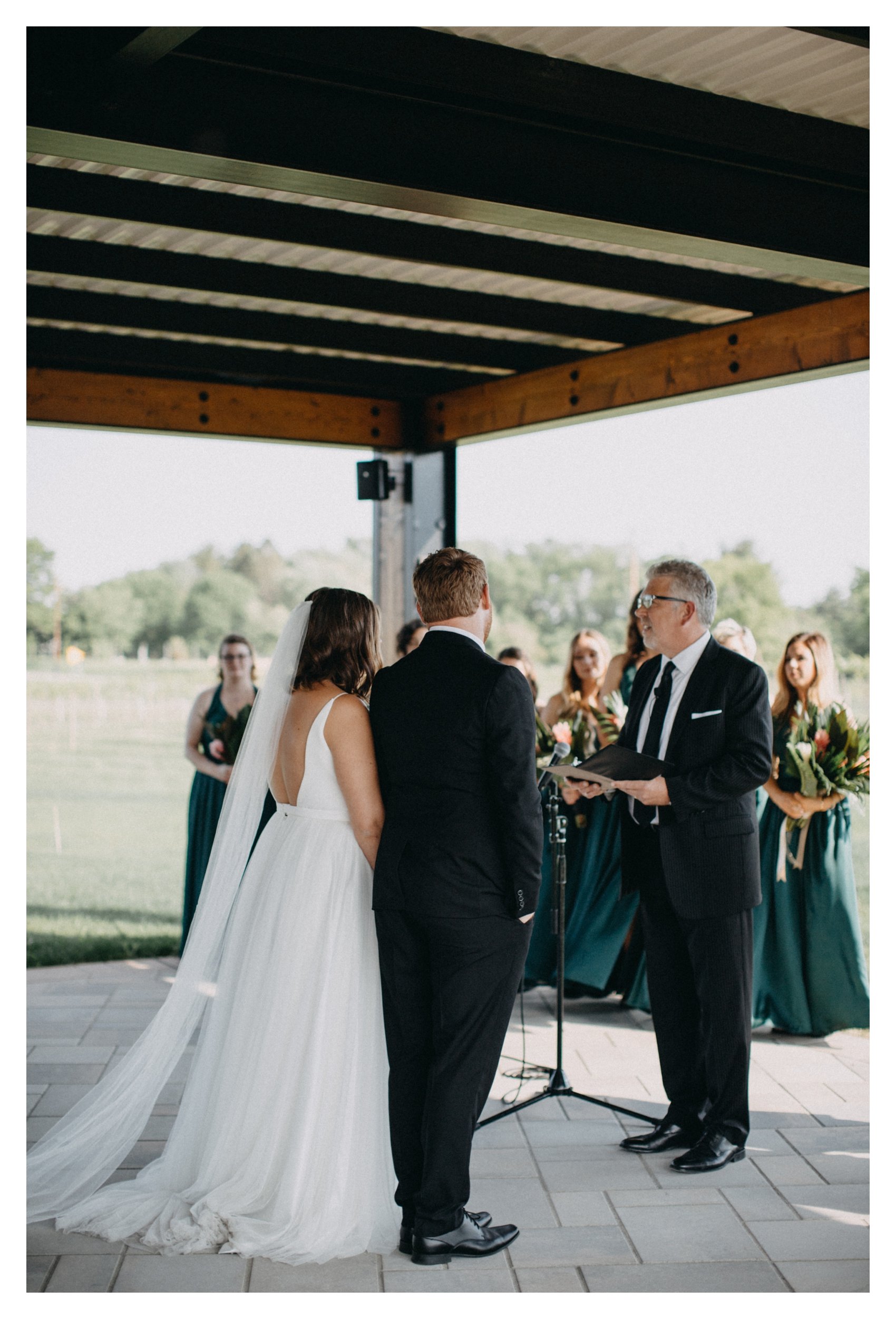 Father of the bride officiating Minnesota vineyard wedding ceremony at 7 Vines winery