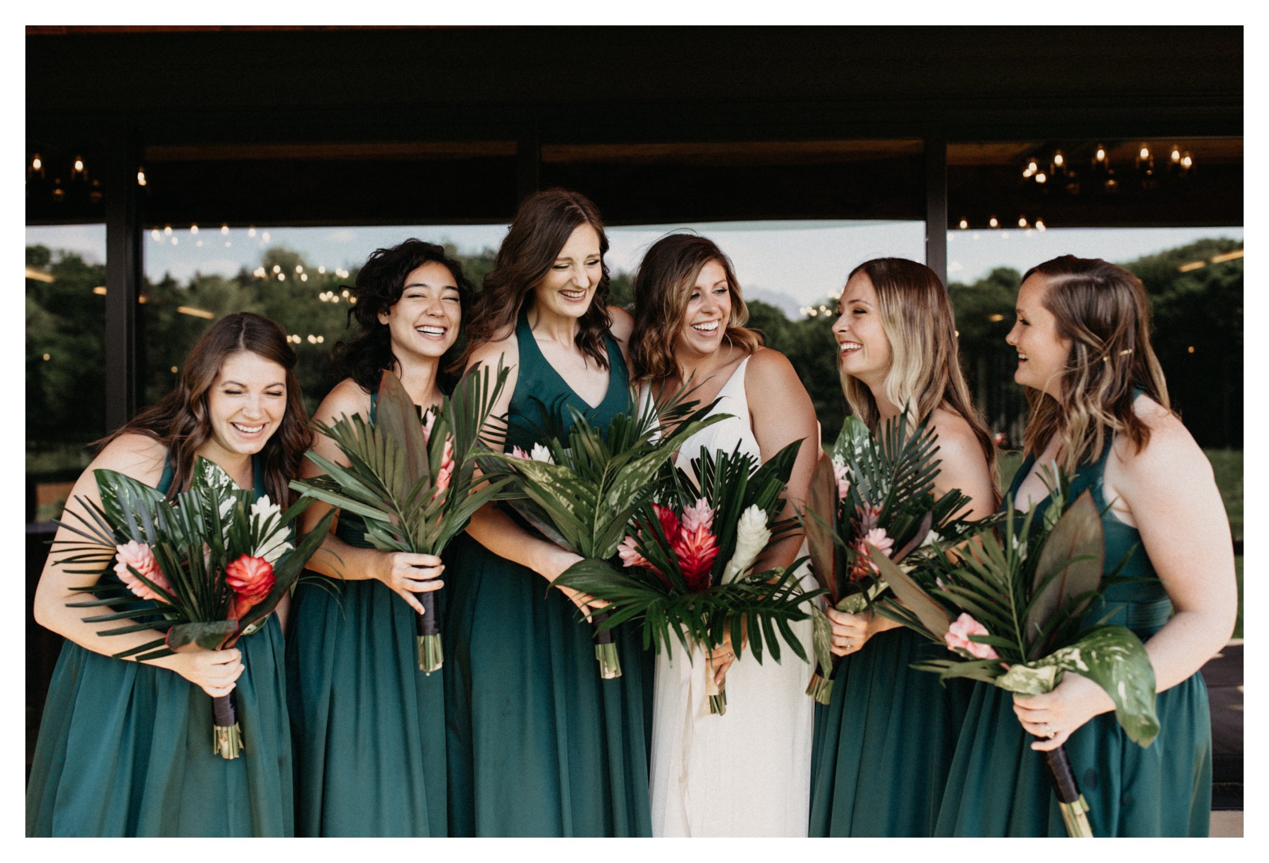 Bride and bridesmaids laughing before 7 Vines Minnesota vineyard wedding