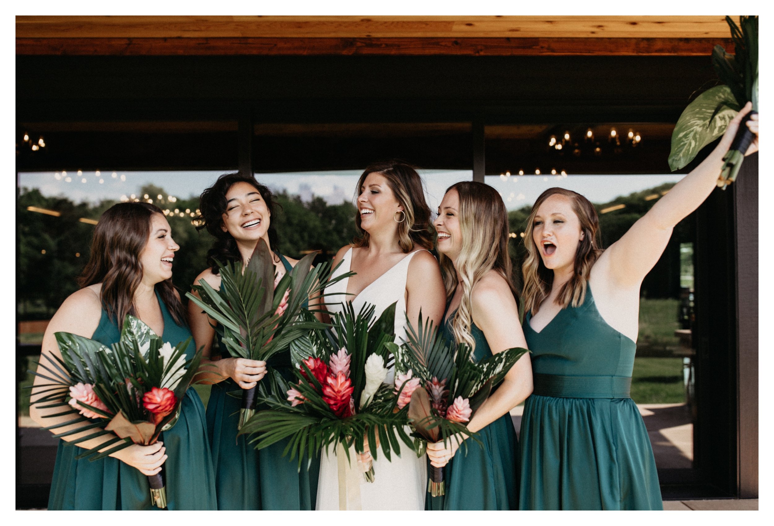 Bride and bridesmaid laughing and cheering at 7 Vines Minnesota winery wedding