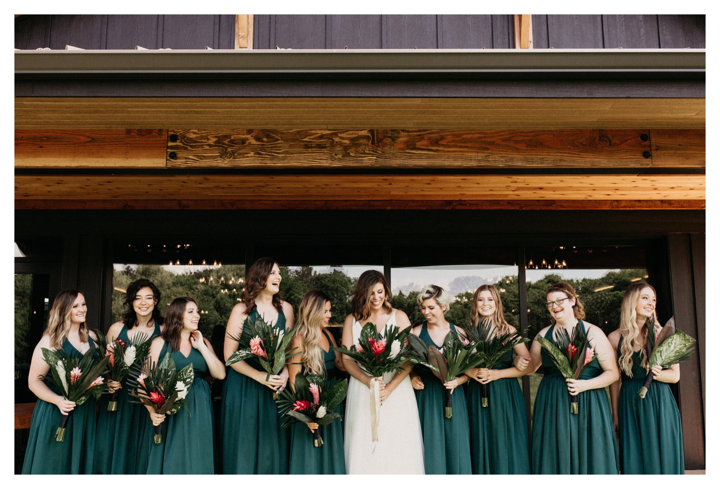 Bride and bridesmaid standing in front of Minnesota vineyard wedding venue