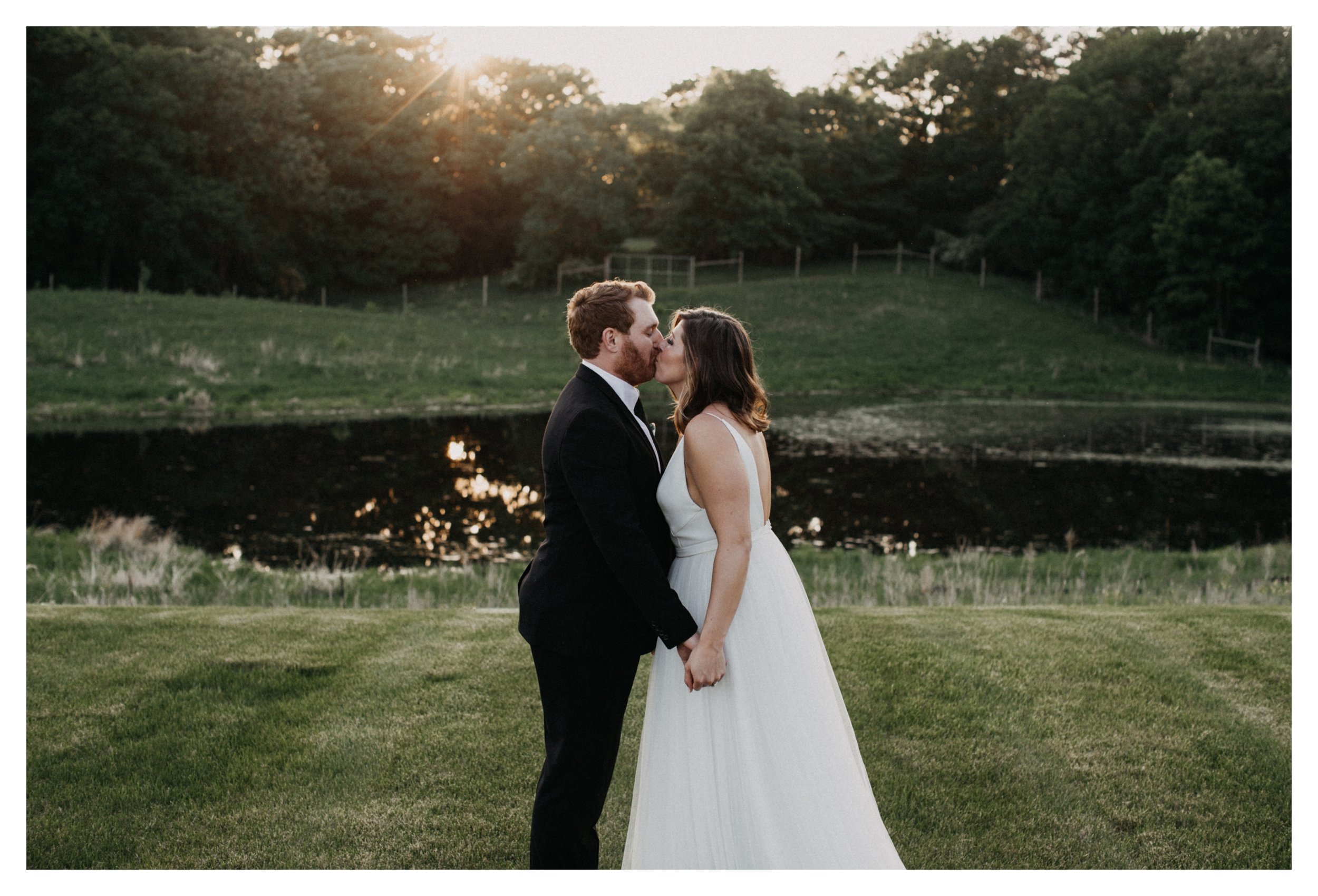 Bride and groom kissing during sunset at Minnesota vineyard wedding venue