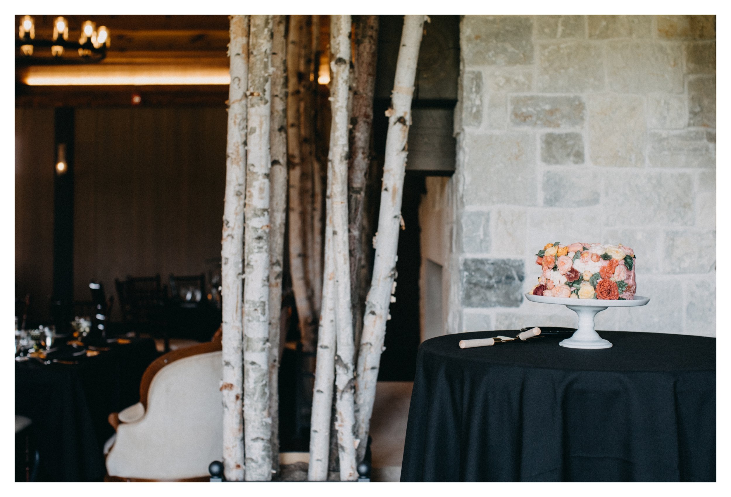 Multi colored floral wedding cake at 7 vines vineyard event space