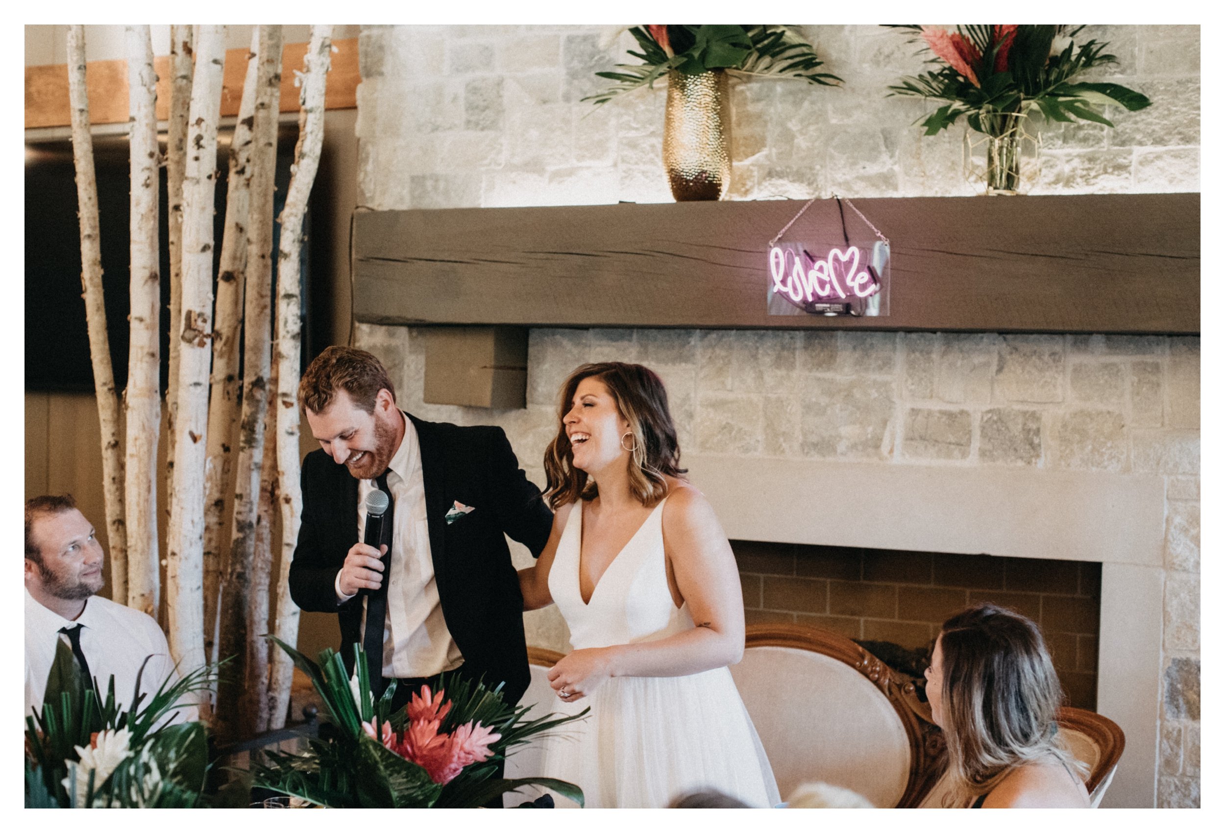 Bride and groom laughing during Minnesota vineyard wedding reception