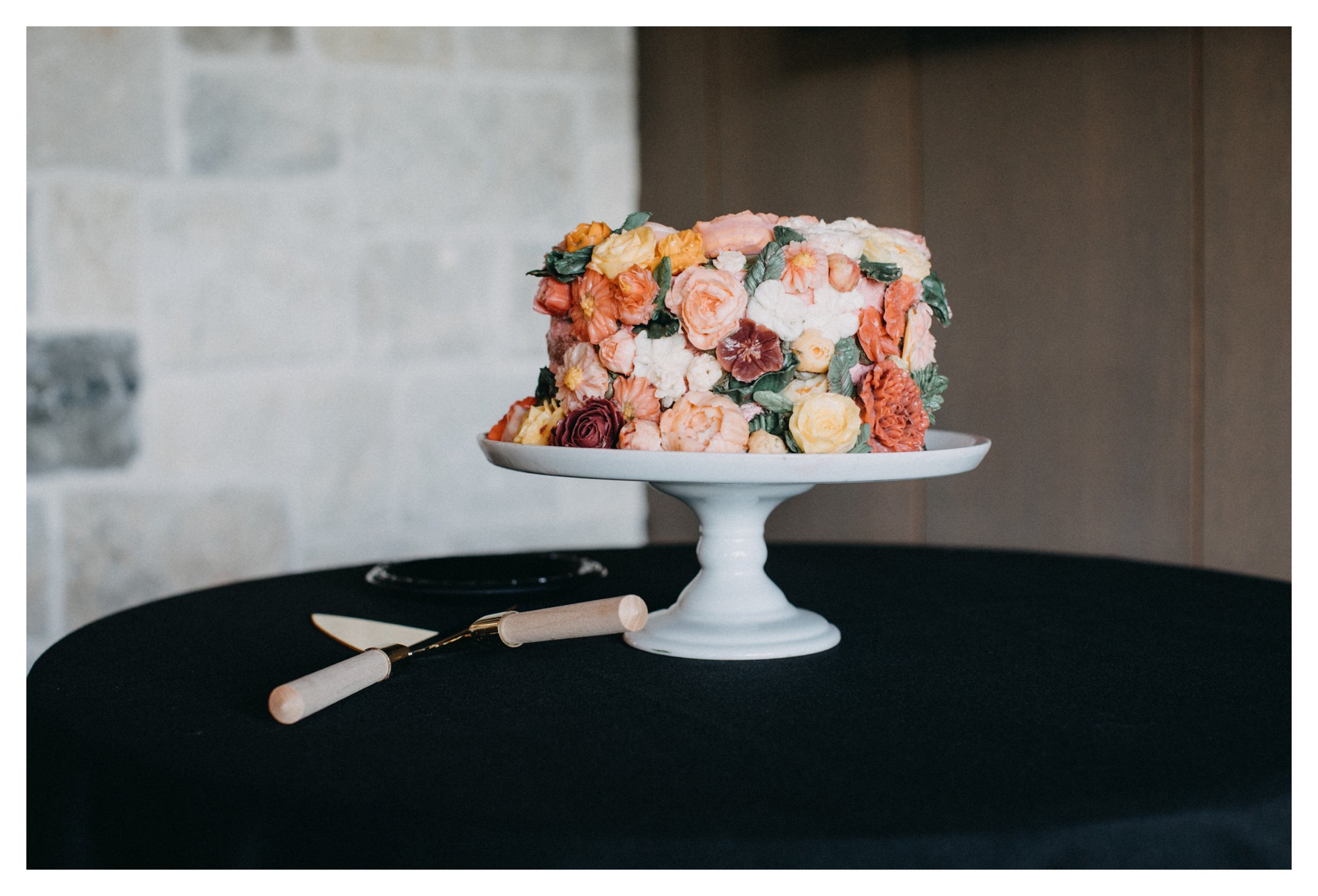 Colorful floral wedding cake during 7 vines vineyard reception