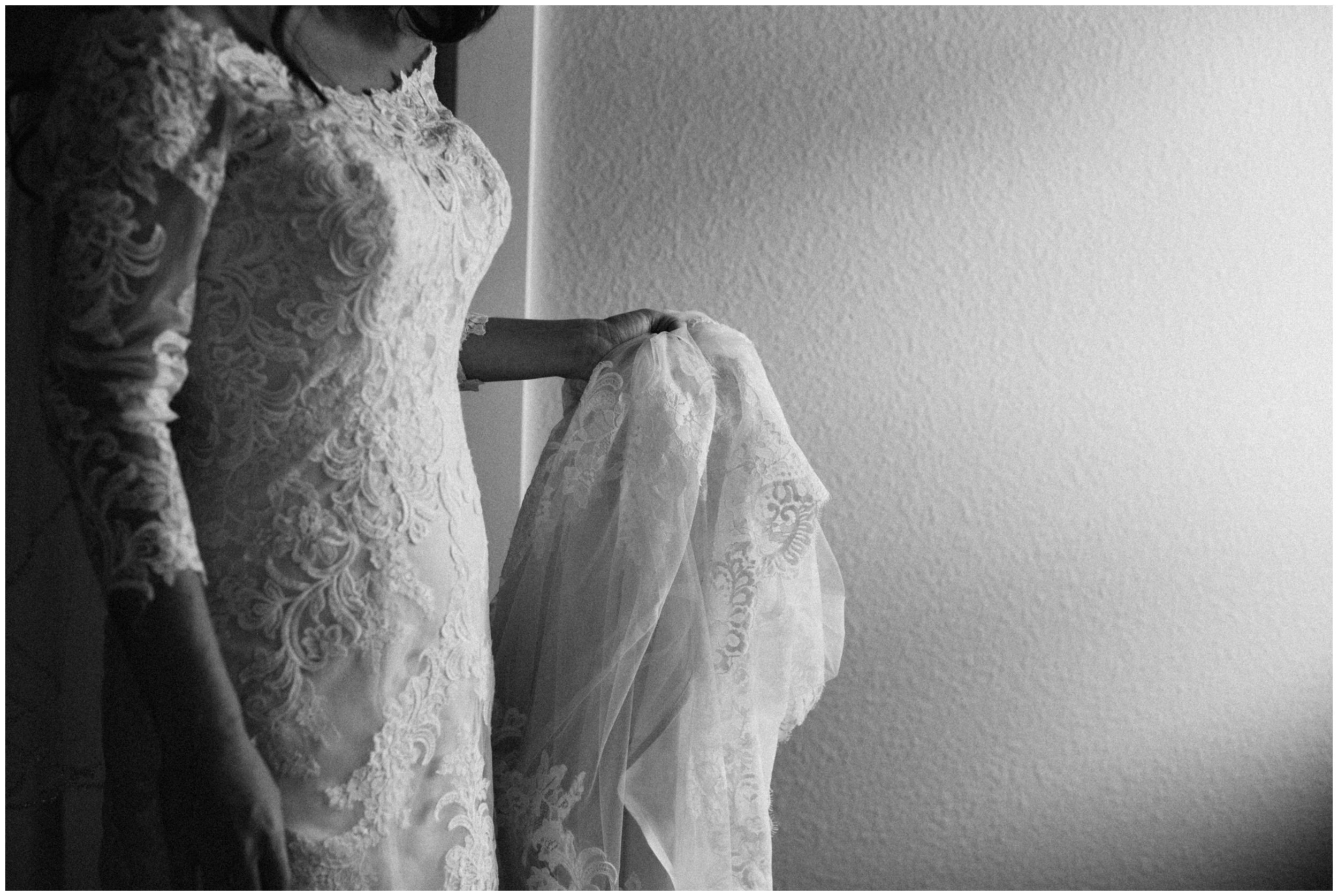 Bride wearing long sleeve lace dress for Gull Lake wedding in Nisswa, Minnesota