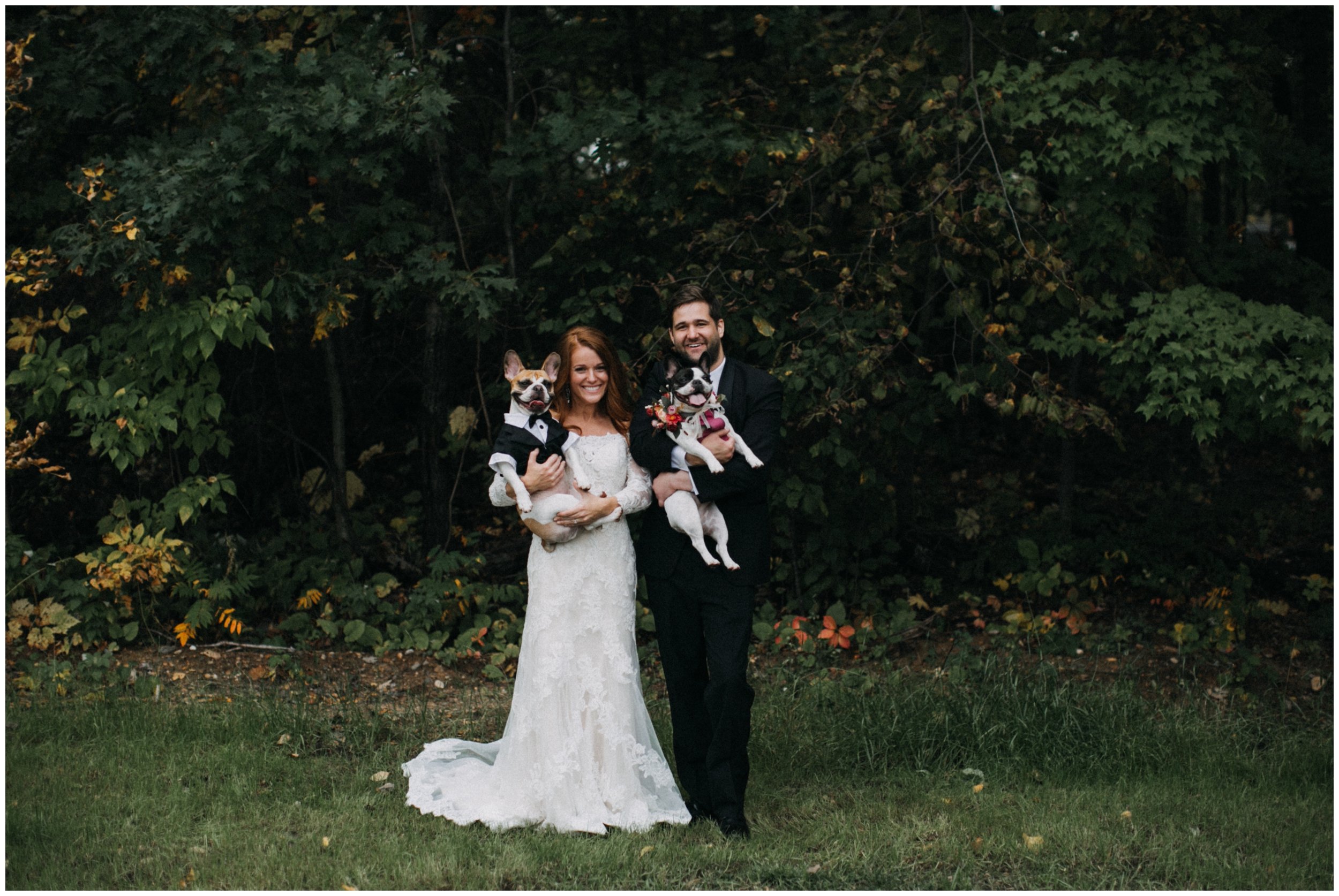 Bride and groom holding french bulldogs at Gull Lake wedding 