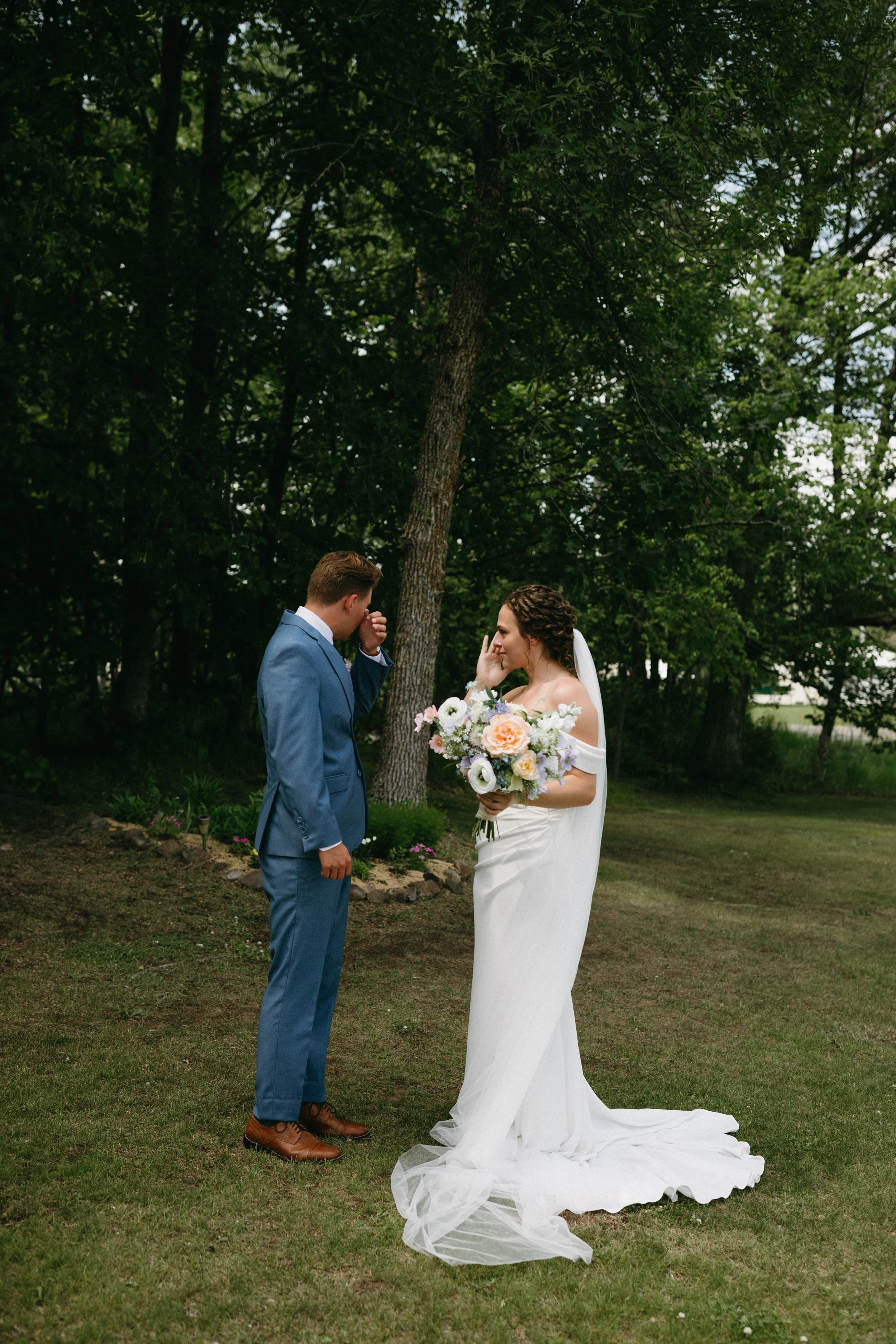 Bride and groom crying during their first look on their wedding day at a barn venue in Minnesota