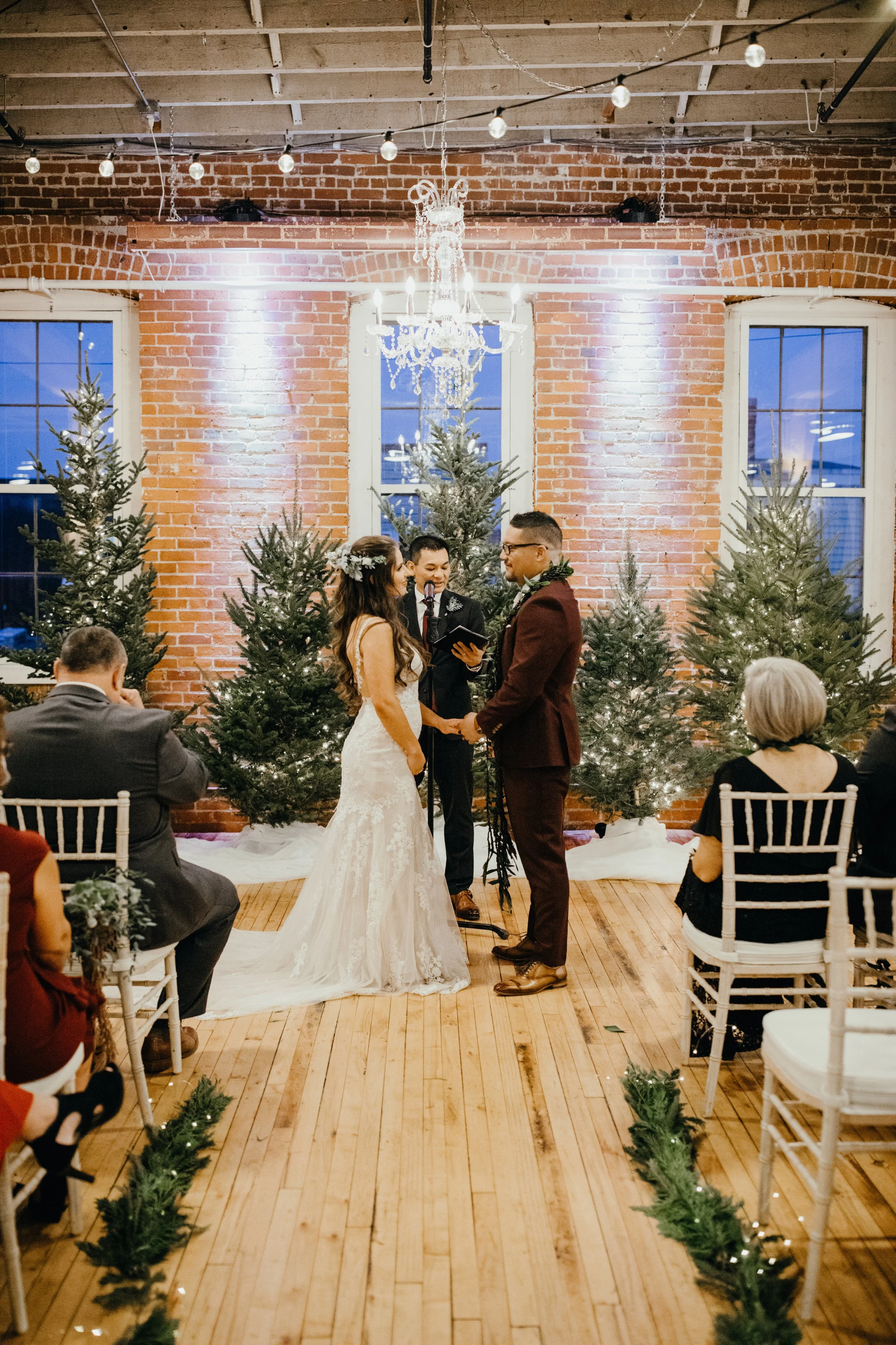 Bride and groom exchanging vows during Stillwater, Minnesota wedding ceremony at JX venue