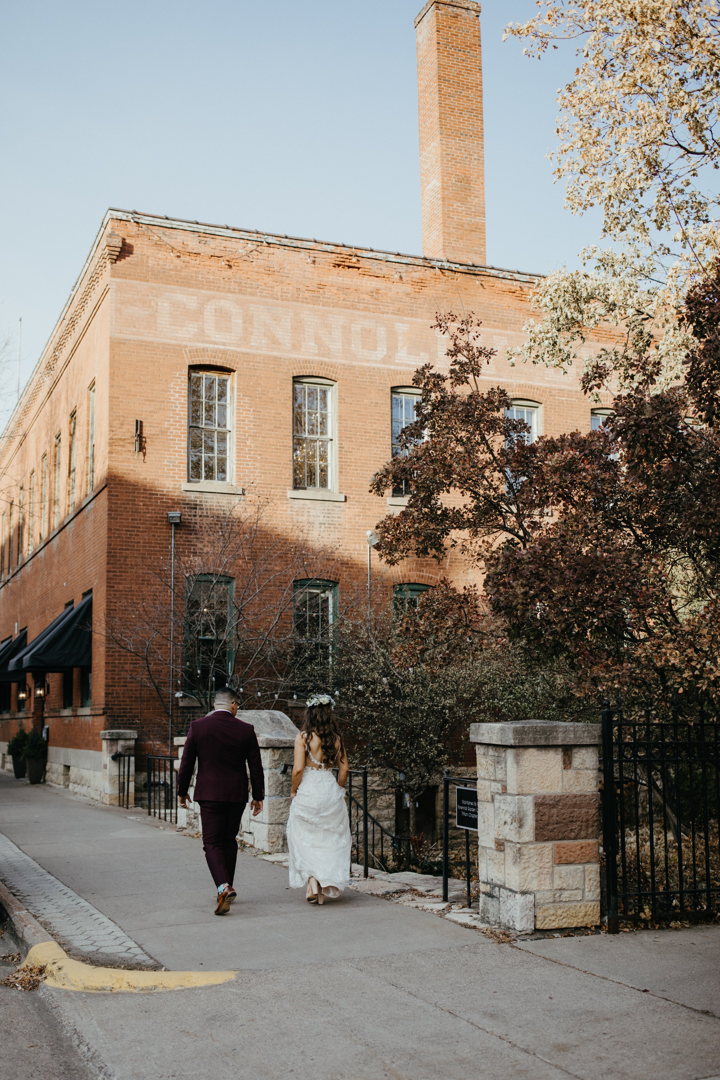 Bride and groom walking outside JX venue in Stillwater, Minnesota