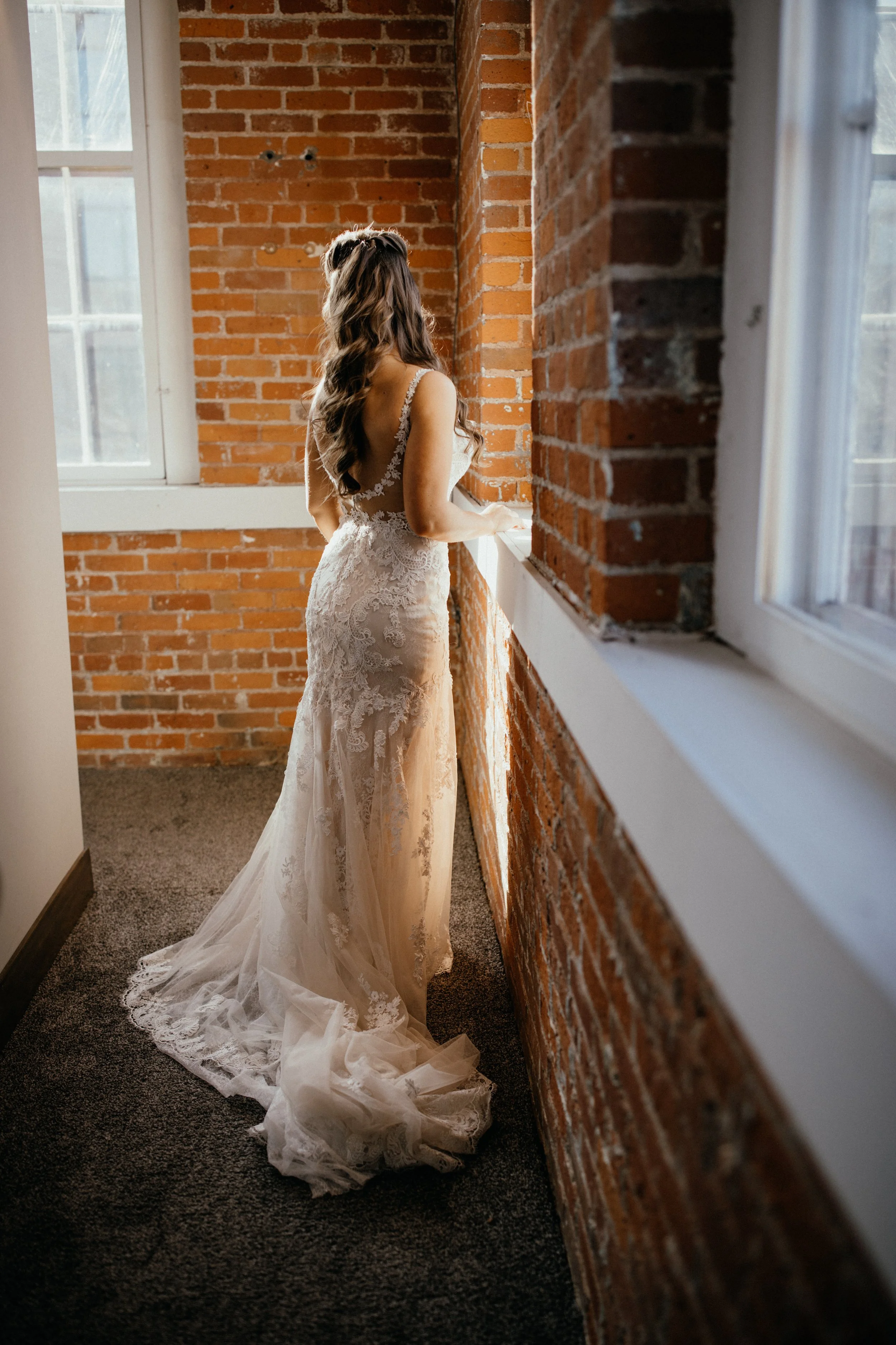 Bride getting into wedding dress at JX venue in Stillwater, MN