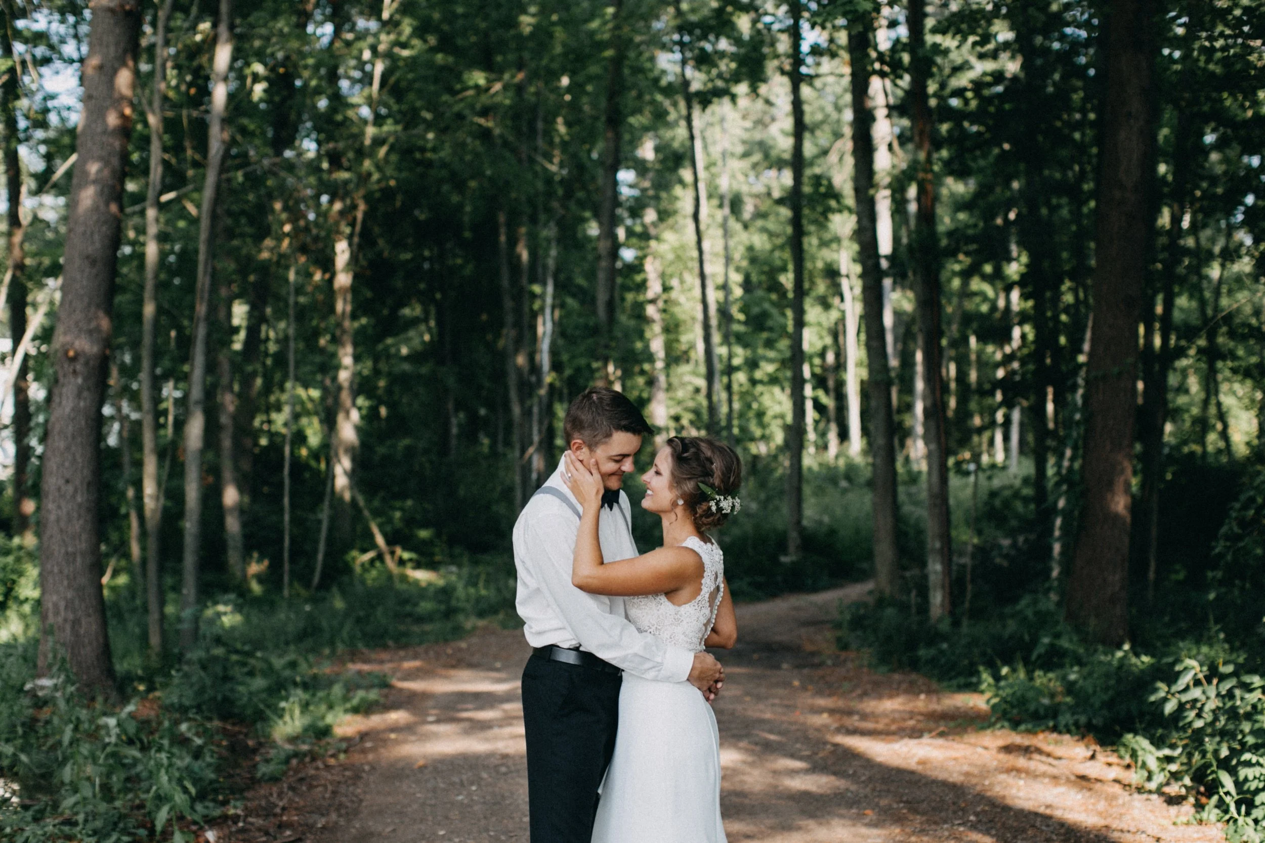 Bride and Groom standing in woods at their Cabin wedding on Lake Edward near Brainerd, Minnesota