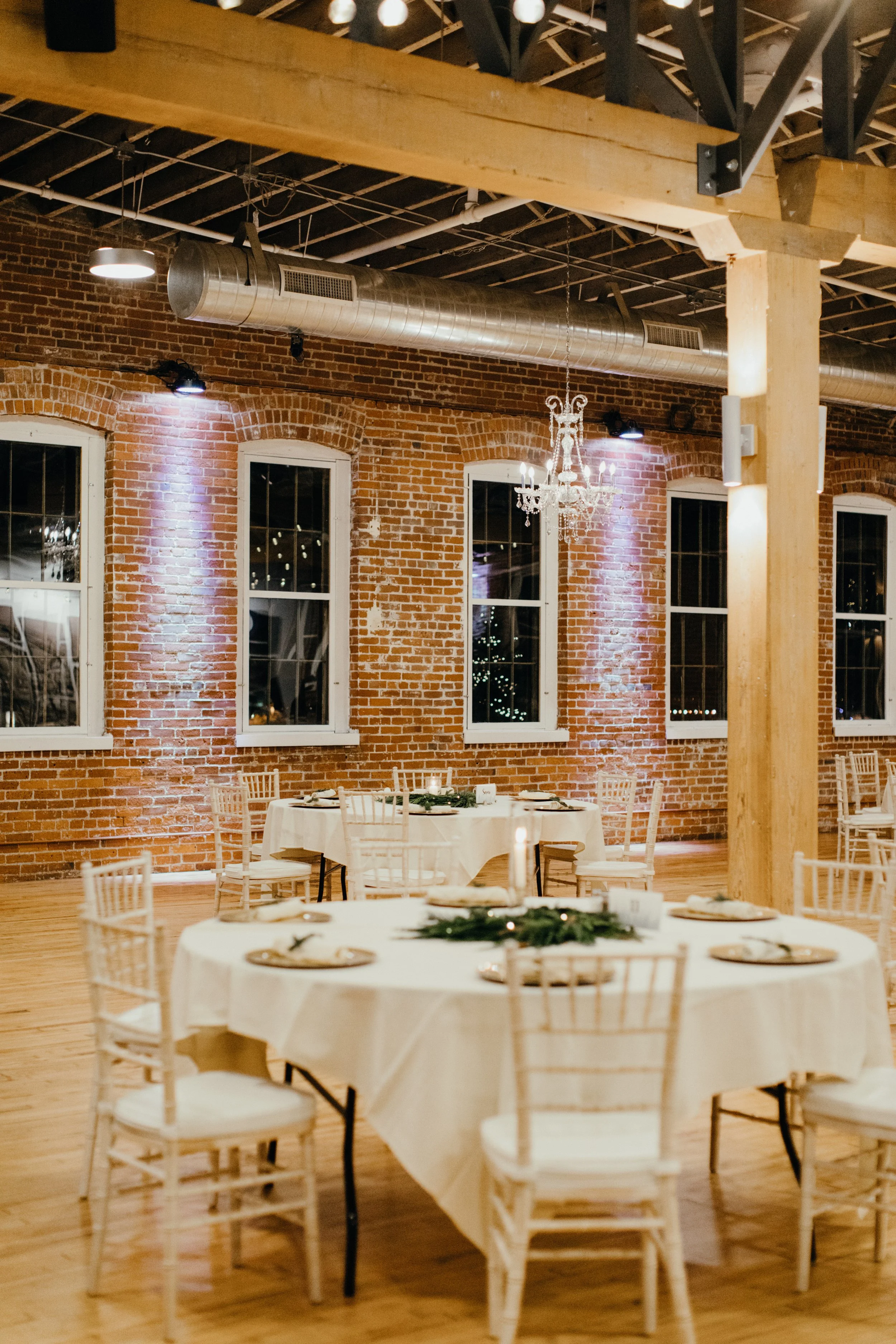 Romantic candlelit industrial wedding reception at JX venue in Stillwater, Minnesota