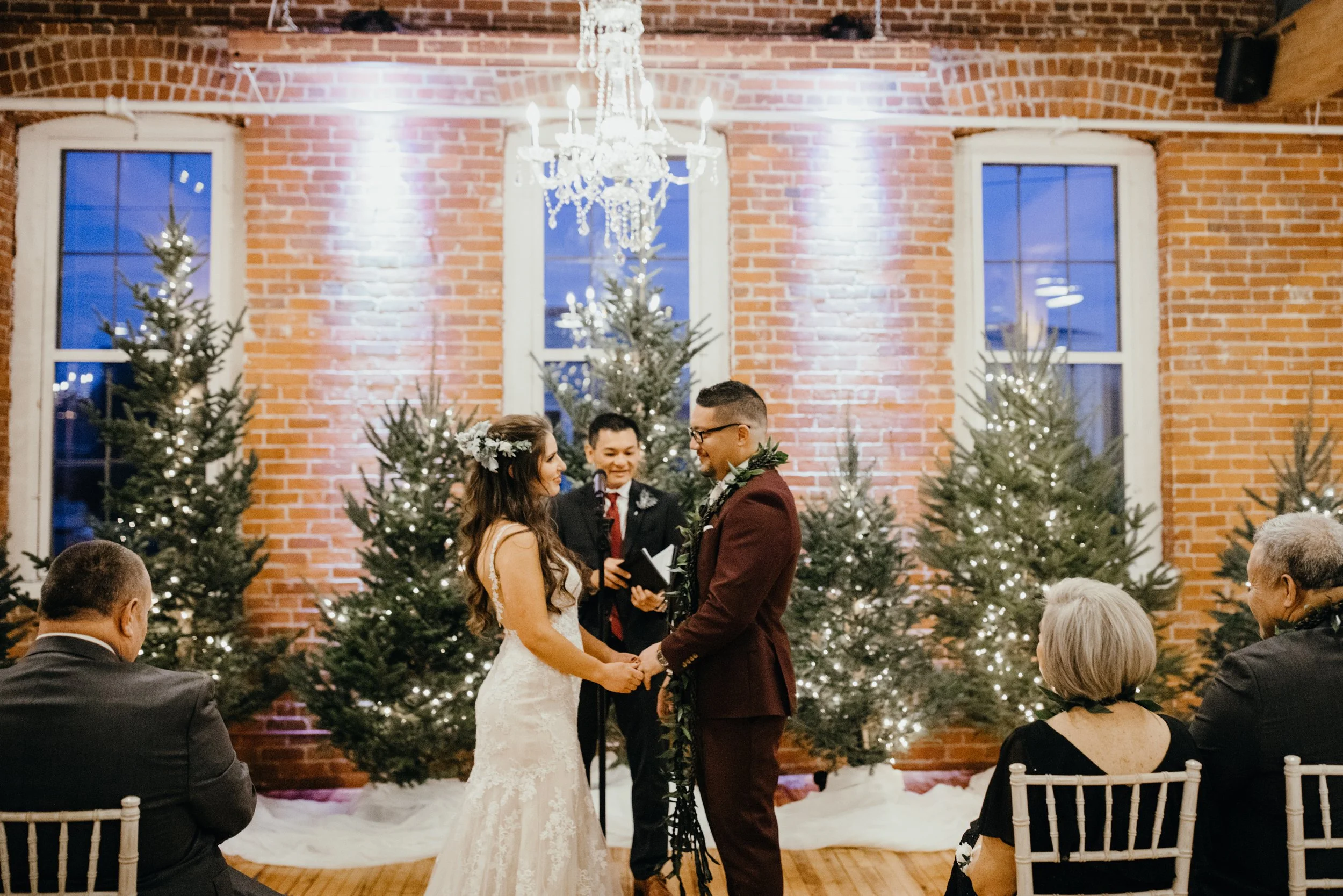 Bride and groom exchanging rings during wedding ceremony at JX venue in Stillwater, Minnesota