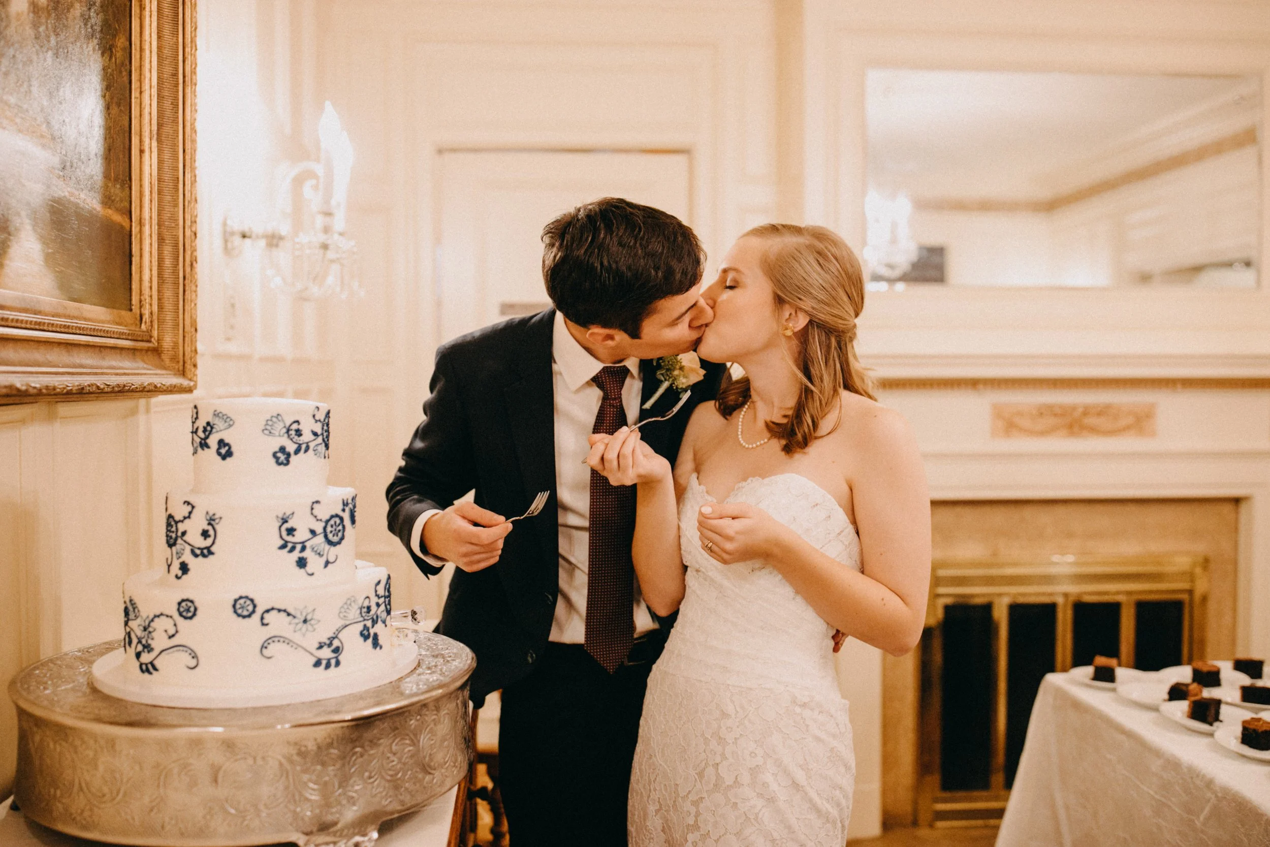 Bride and groom cutting cake during their St Paul College club wedding reception
