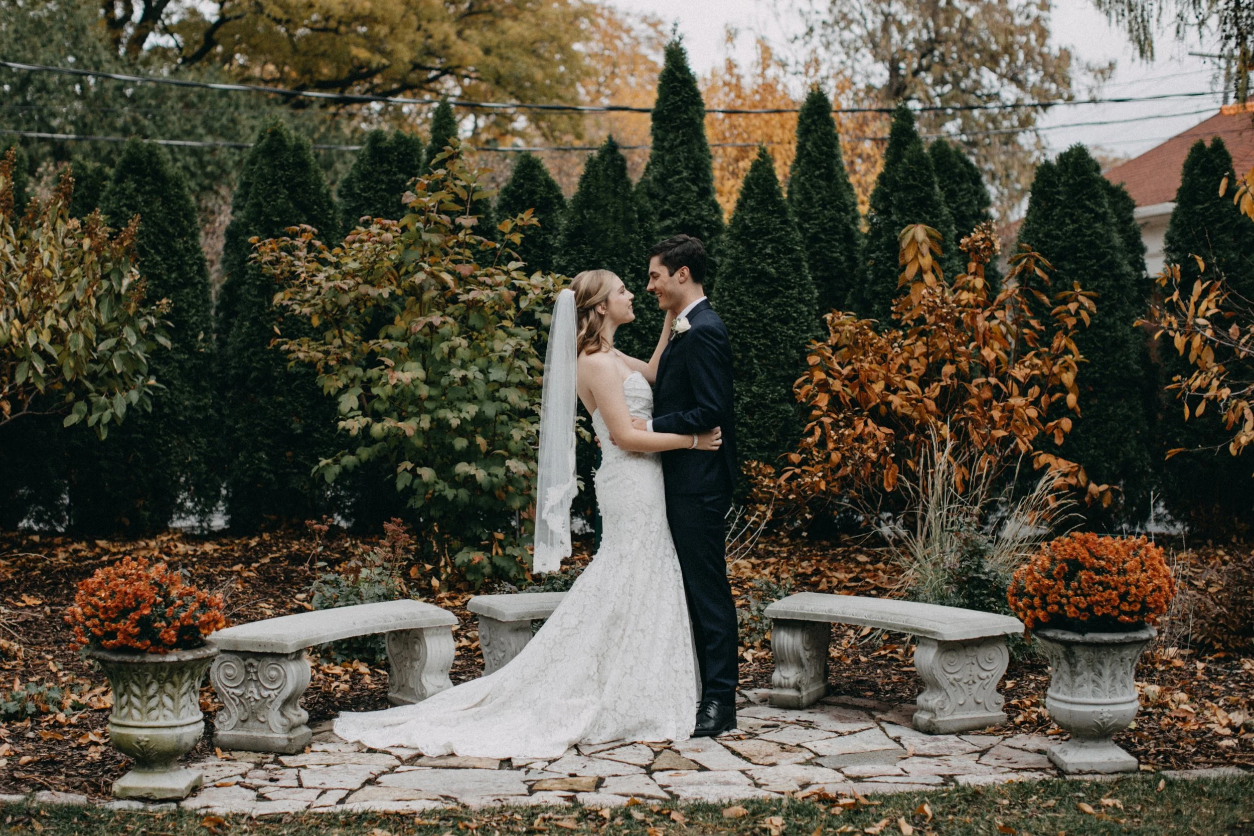 Bride and groom standing St Paul College club backyard on their Minnesota fall wedding day