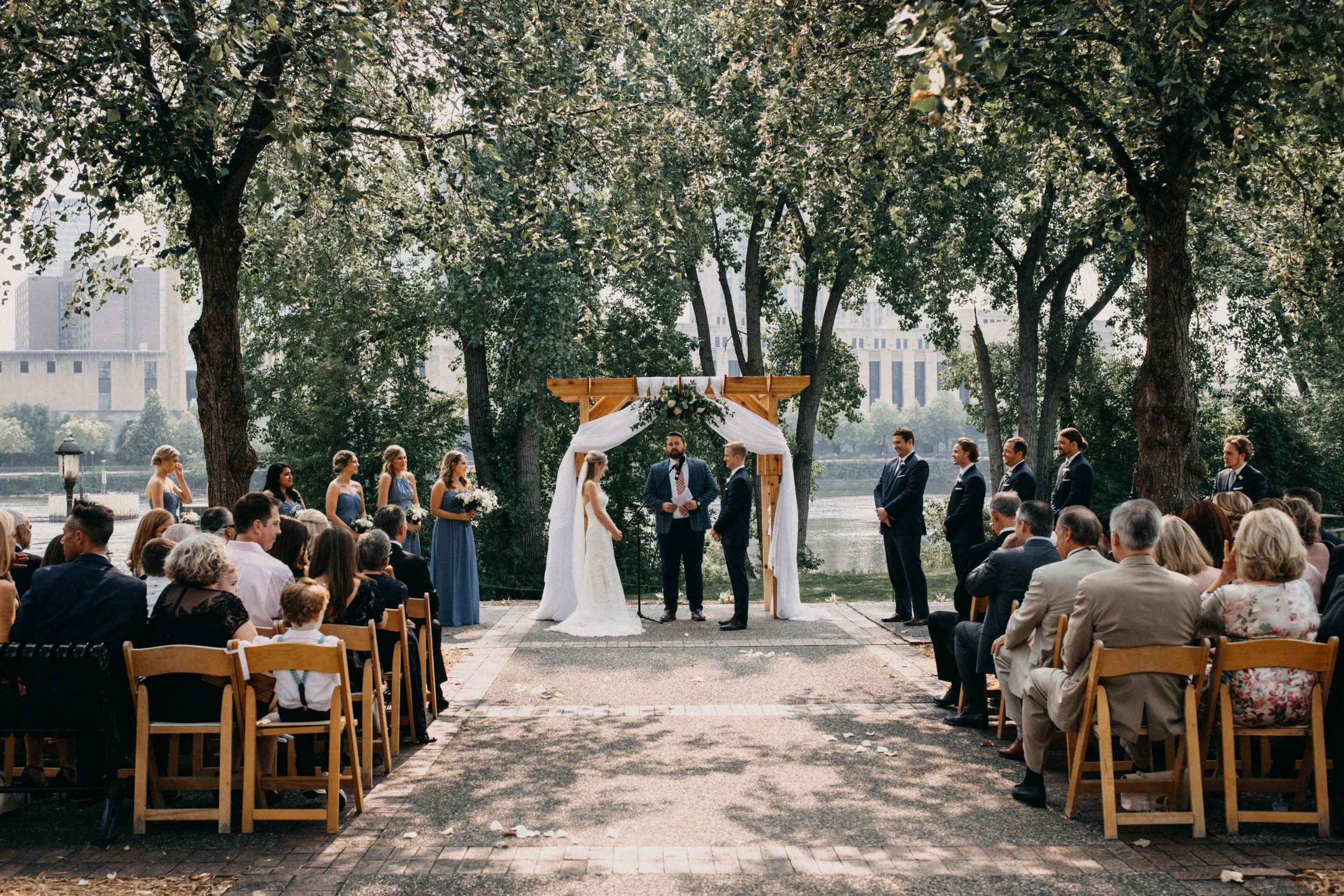 Outdoor wedding ceremony overlooking the Mississippi River at Nicollet Island Pavilion in Minneapolis, Minnesota