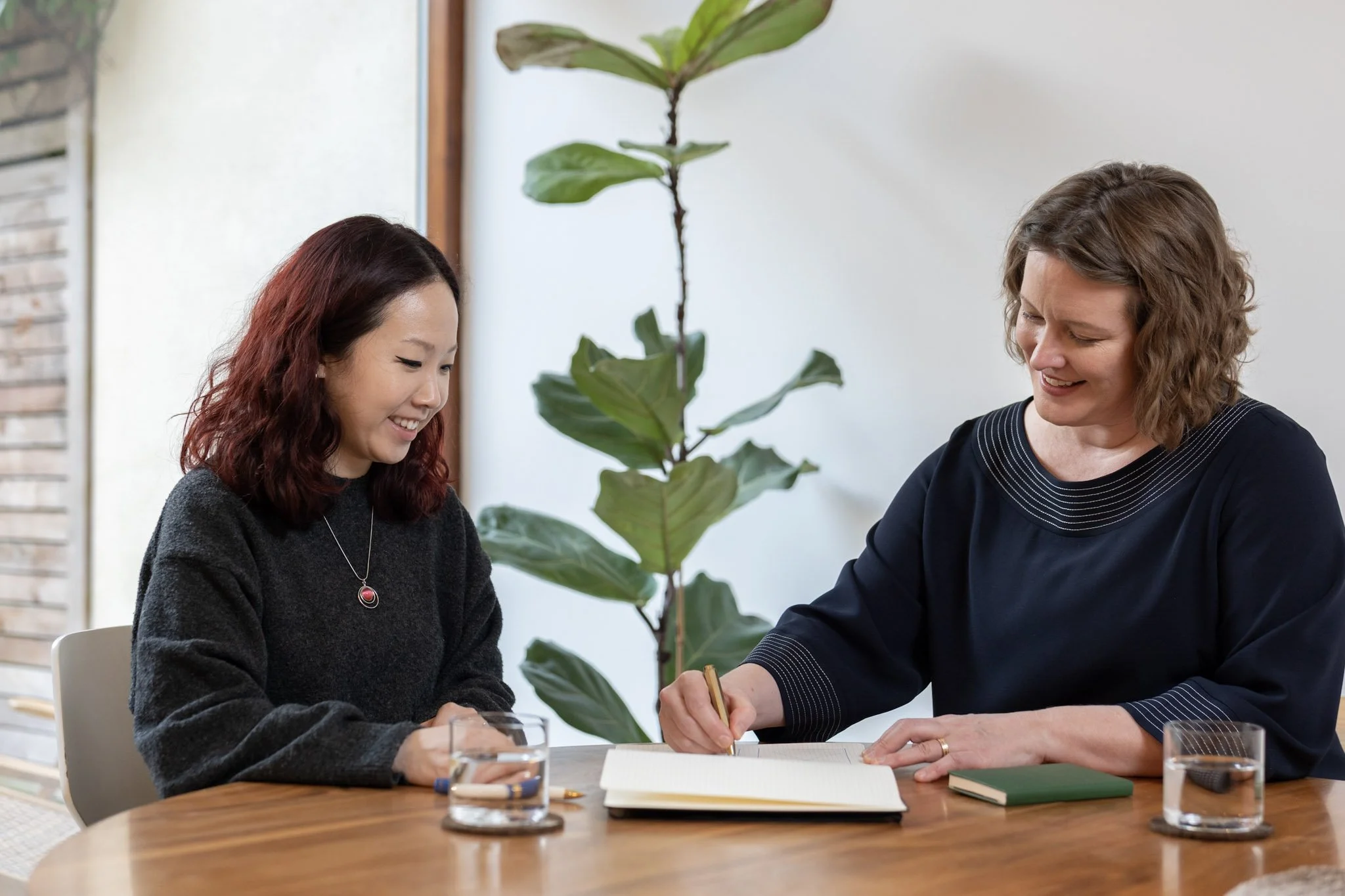 Meg Rye providing coaching to a woman with mid-length wavy hair