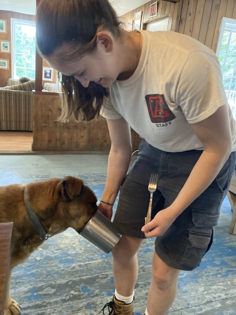 Talia Ferris sneaking a snack to Jasper in the Dining Hall