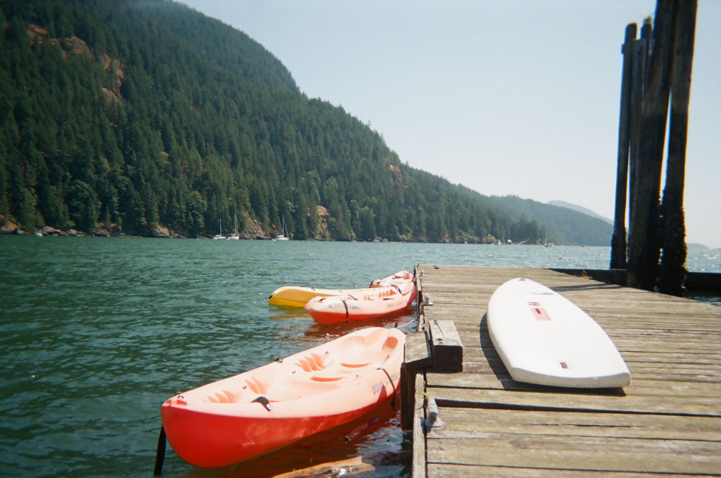 Kayaks and windsurfing boards on the waterfront