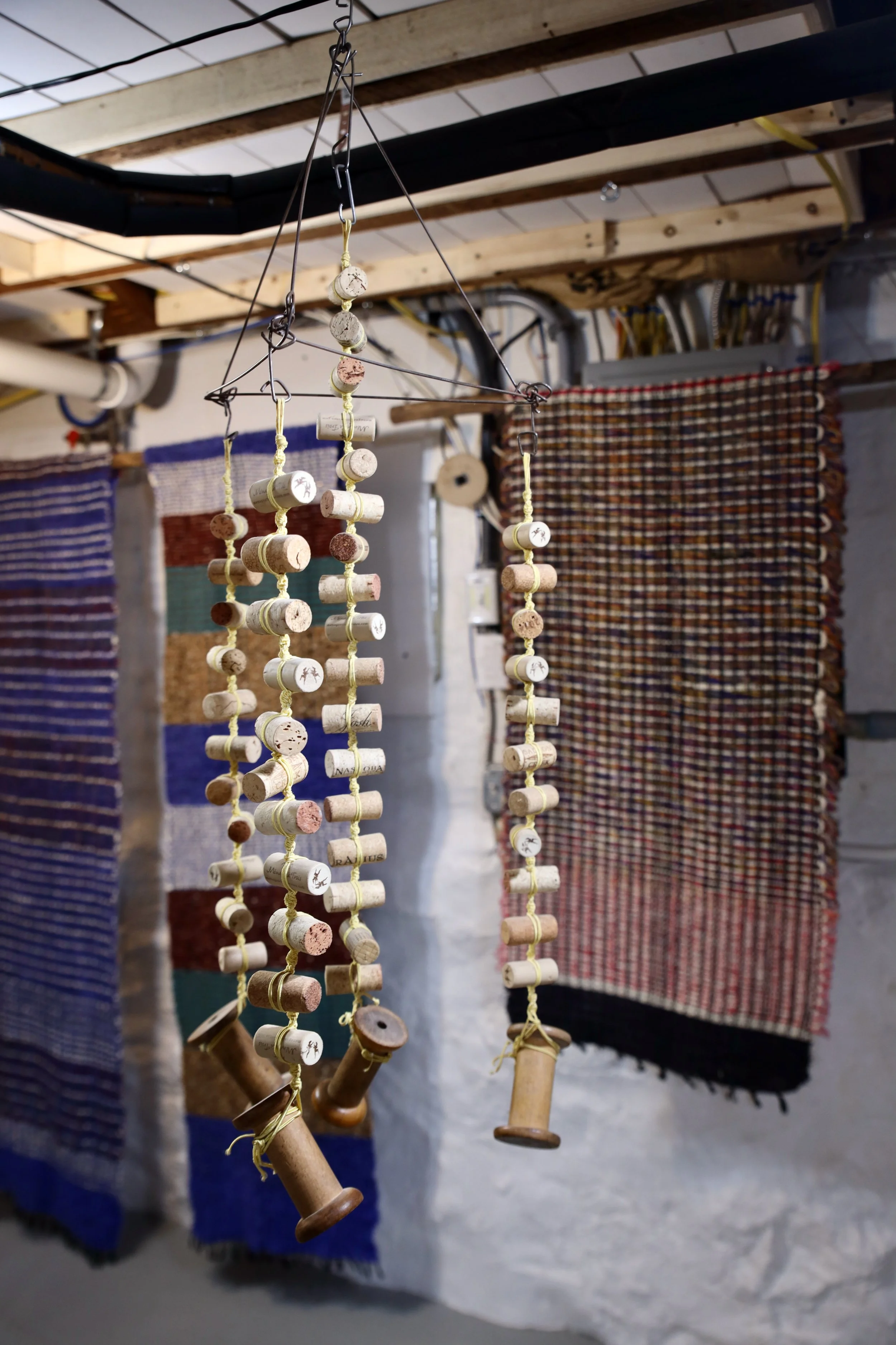 Cork and Wooden Spools, 2019, 36 x 14,x 14 Pyramid Shaped Steel Wire Frame with Cork Strings Terminating in Wooden Spools