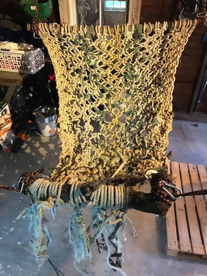 Large macrame panel used as hammock, found ocean 3/8” line, upcycled expandable garden hose, and square knots, 2017