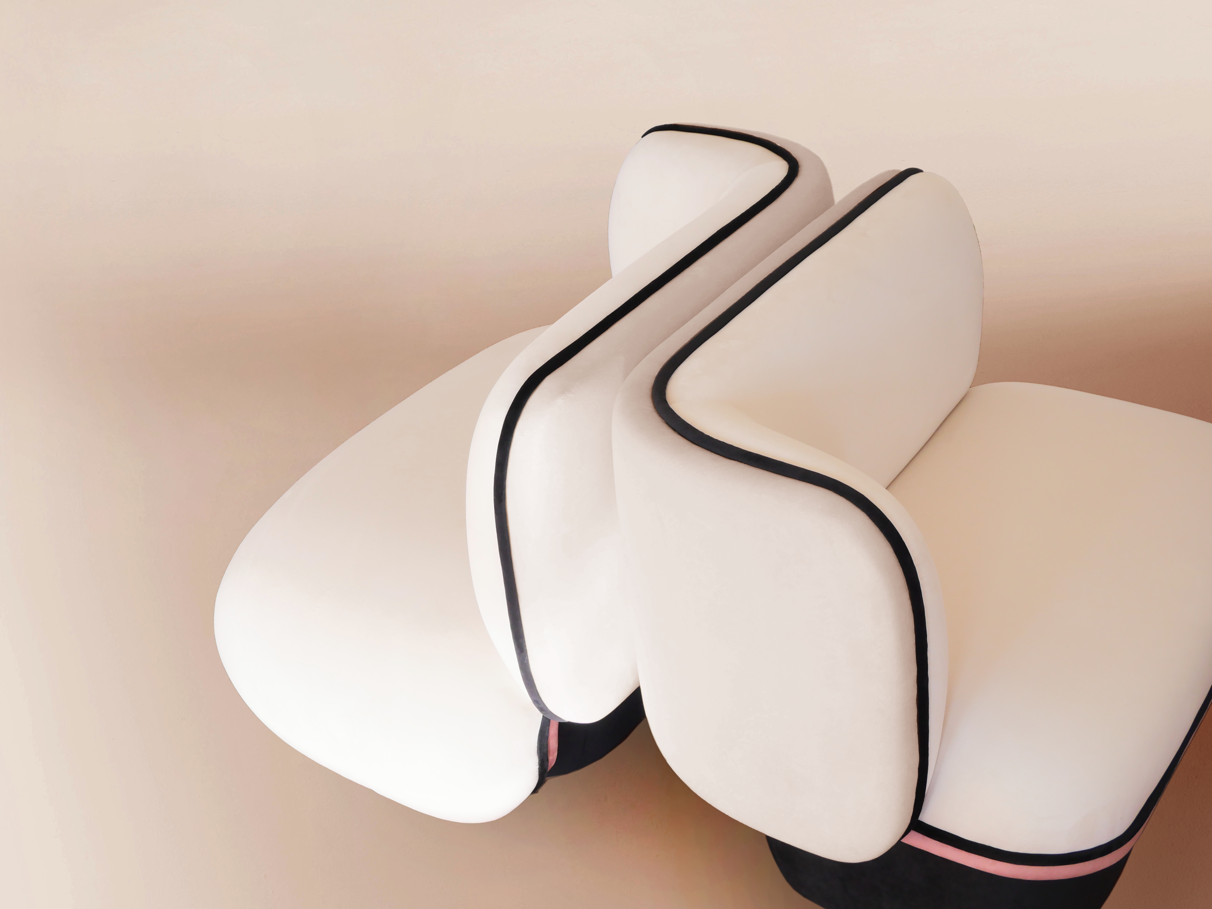 Close-up of a modern, abstract white and black sculpture with smooth, flowing curves and black trim accents.