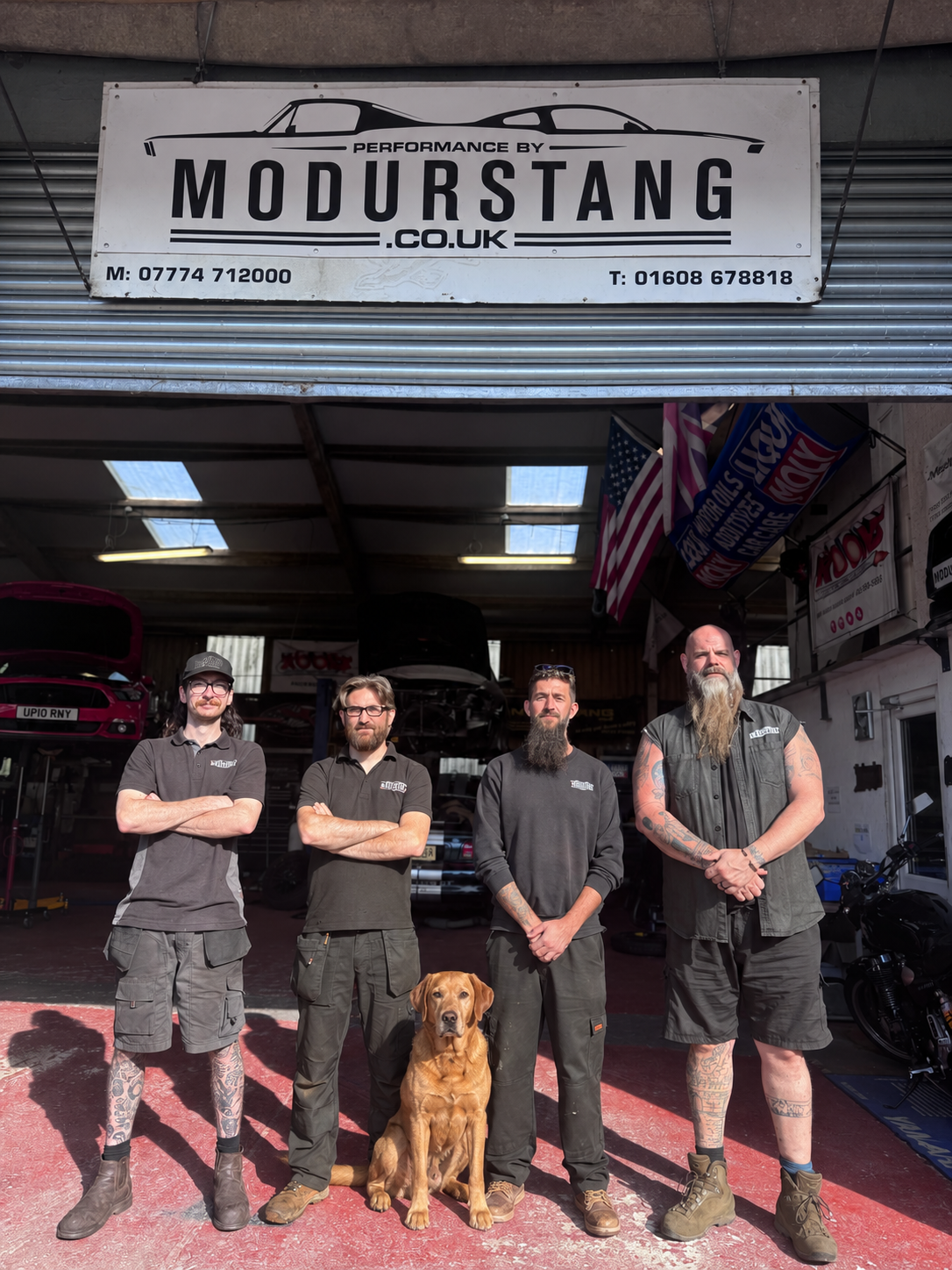 Oli, Lee, Brad and Daz outside the Modurstang workshop, with Flint the dog