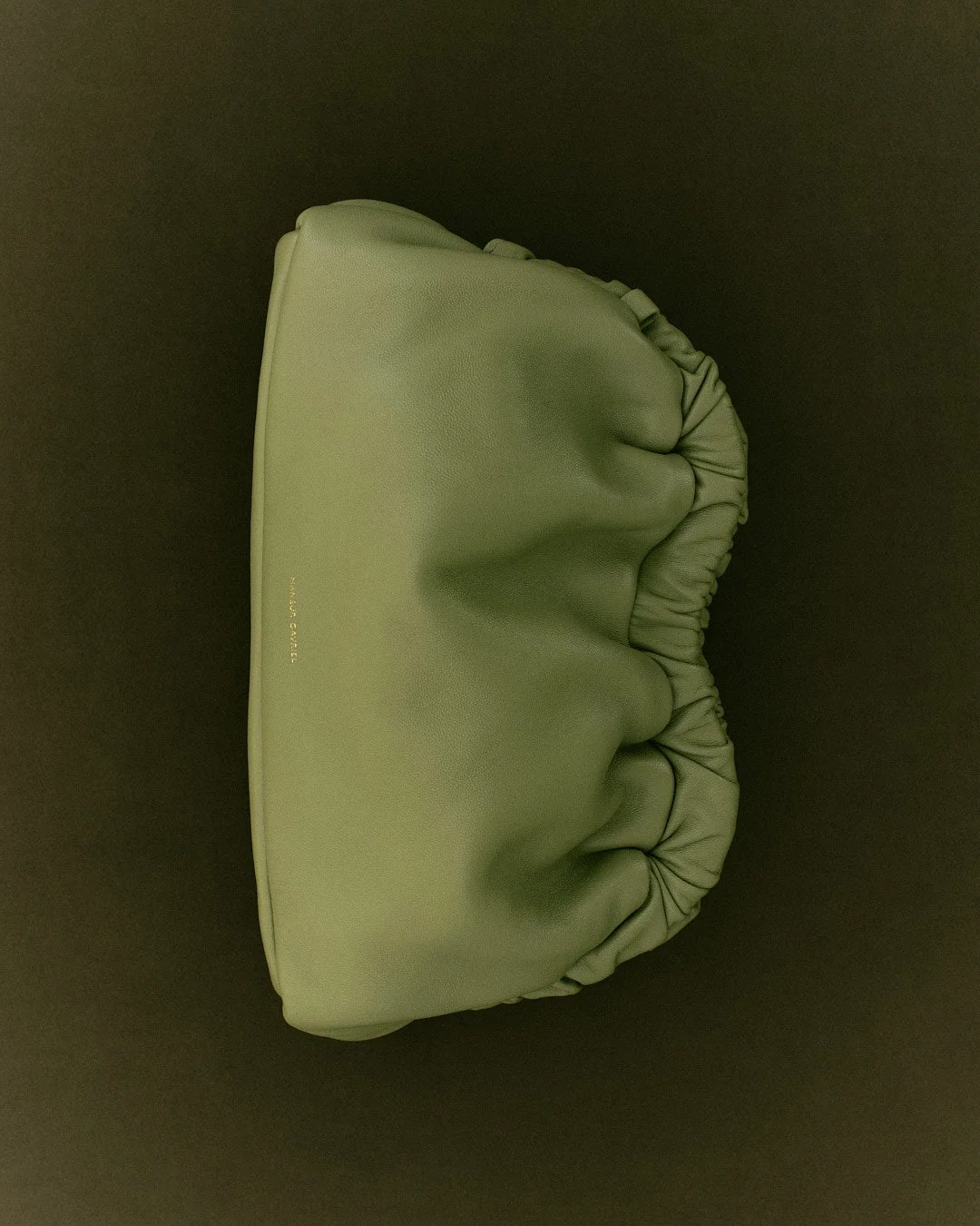 green-ruched-leather-clutch-gold-hardware-accessories-product-photography-editorial-soft-goods-mansur-gavriel.jpg
