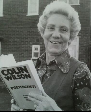 Jean Pritchard holding book about event