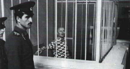 Chikatilo in his cage in the courtroom