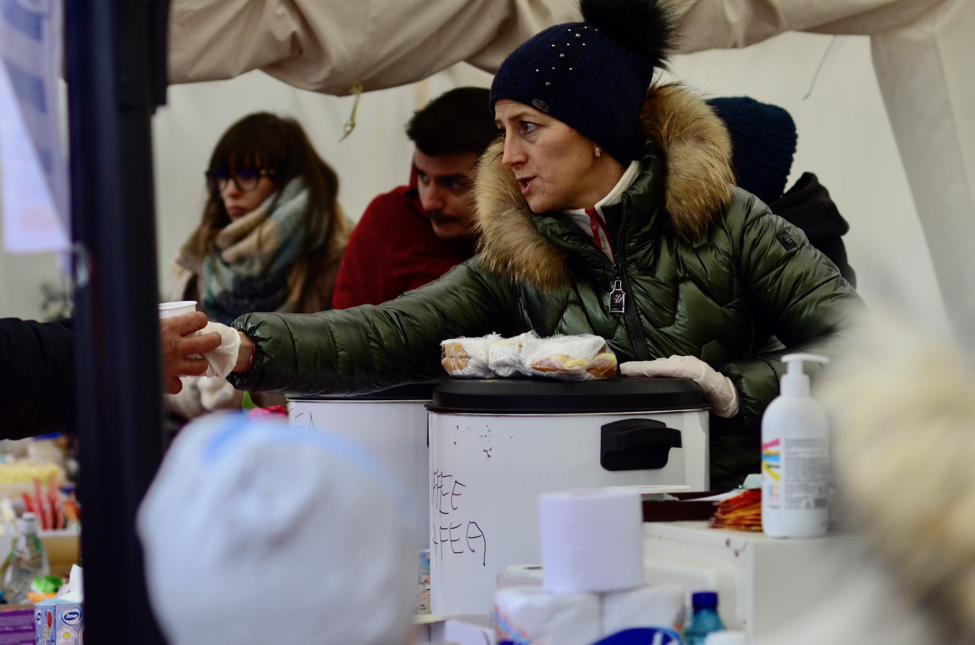 Volunteers offer hot tea and coffee to those arriving at Isaccea