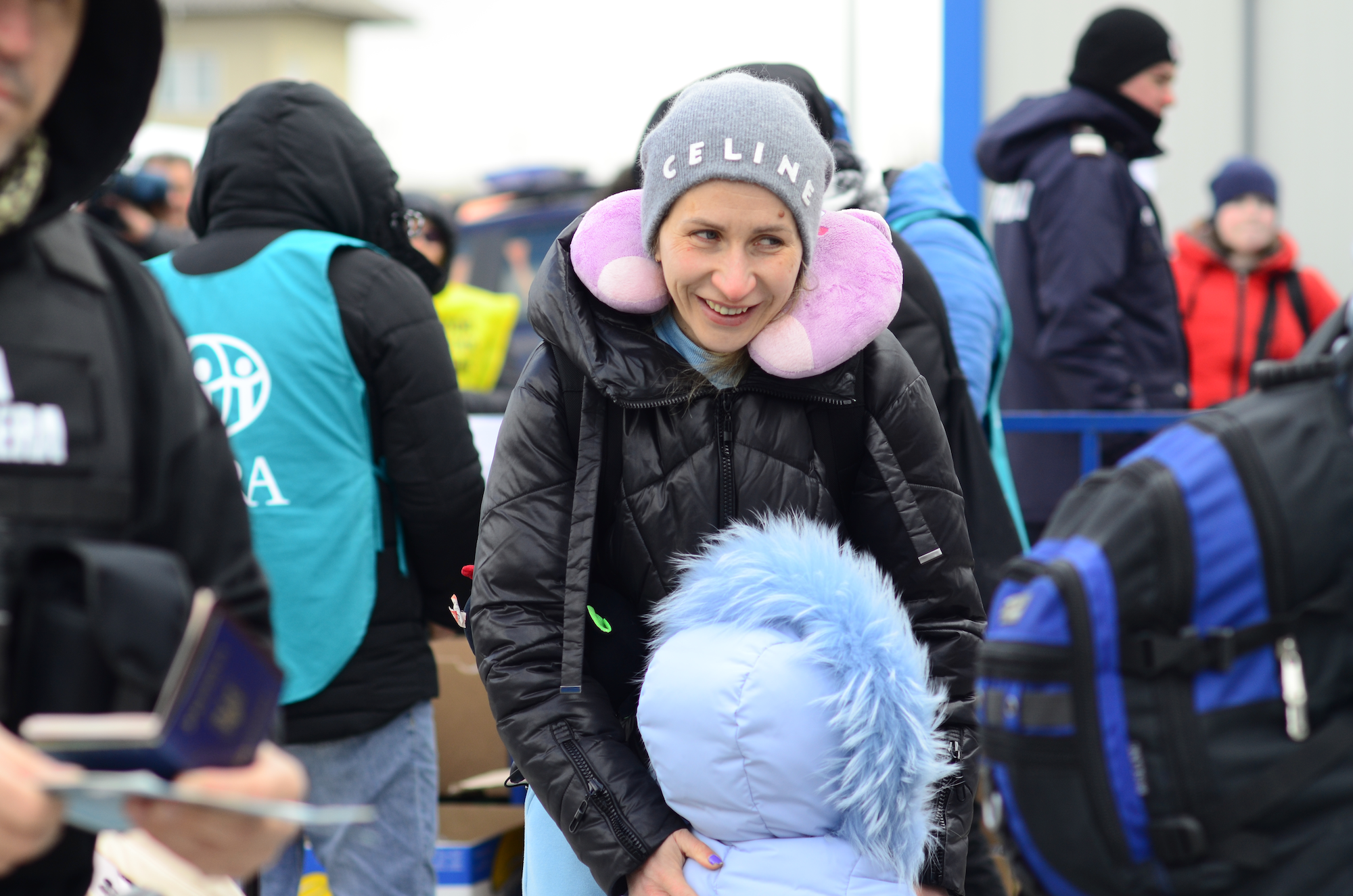 Nastya, from Odessa, keeps her daughter's spirits up as they wait in the queue for border control