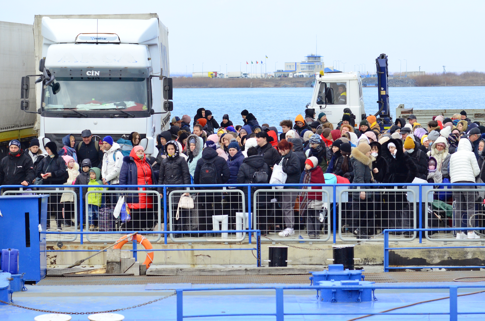 Refugees wait to disembark the ferry