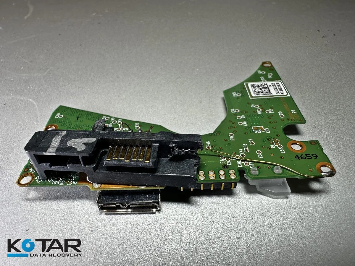 Damaged USB flash drive circuit board with broken connector undergoing professional data recovery