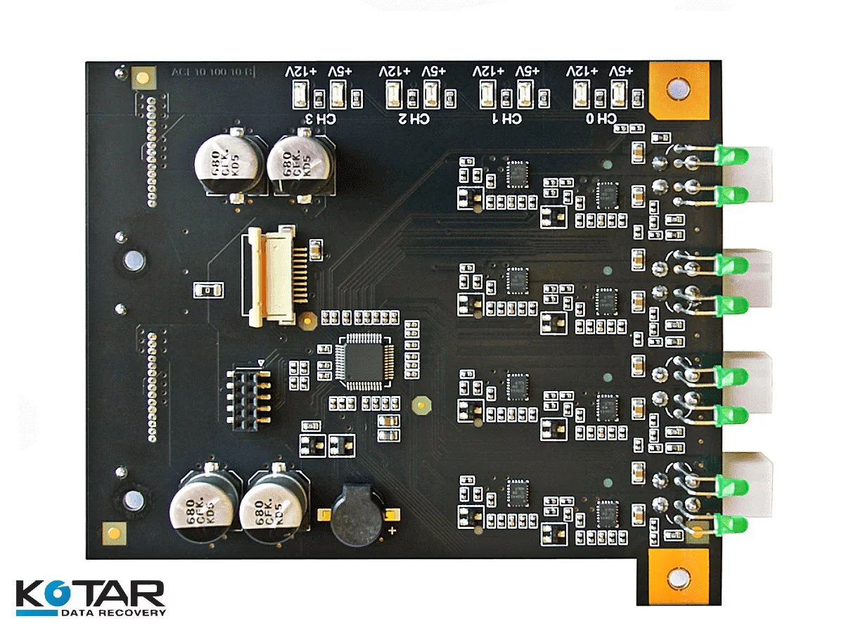 Close-up of a printed circuit board (PCB) with capacitors, connectors, and green terminal blocks, used in advanced data recovery and electronic diagnostics at Kotar Data Recovery.