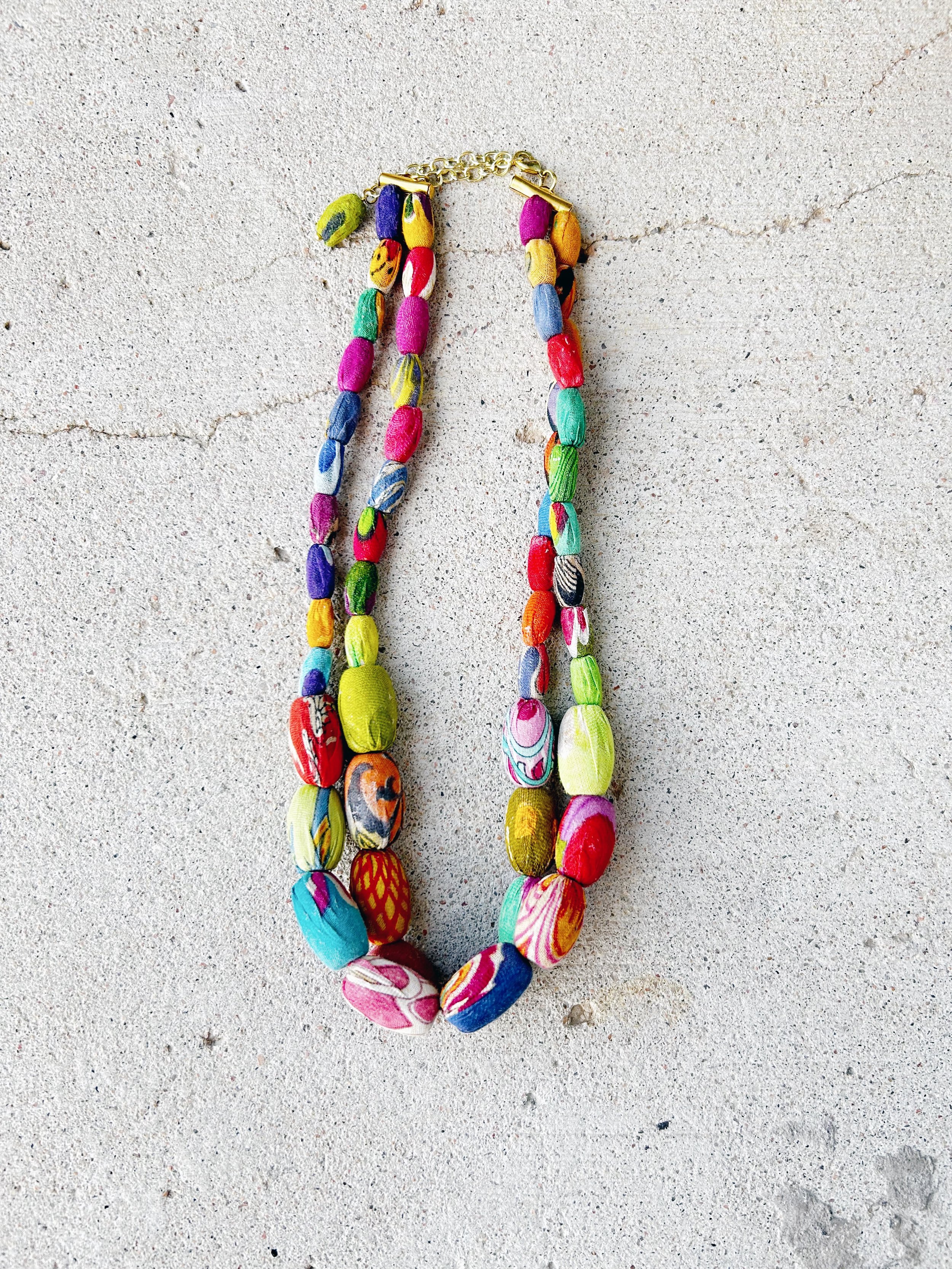 The Elliptical Layers Kantha Necklace features two rows of colorful Kantha beads.