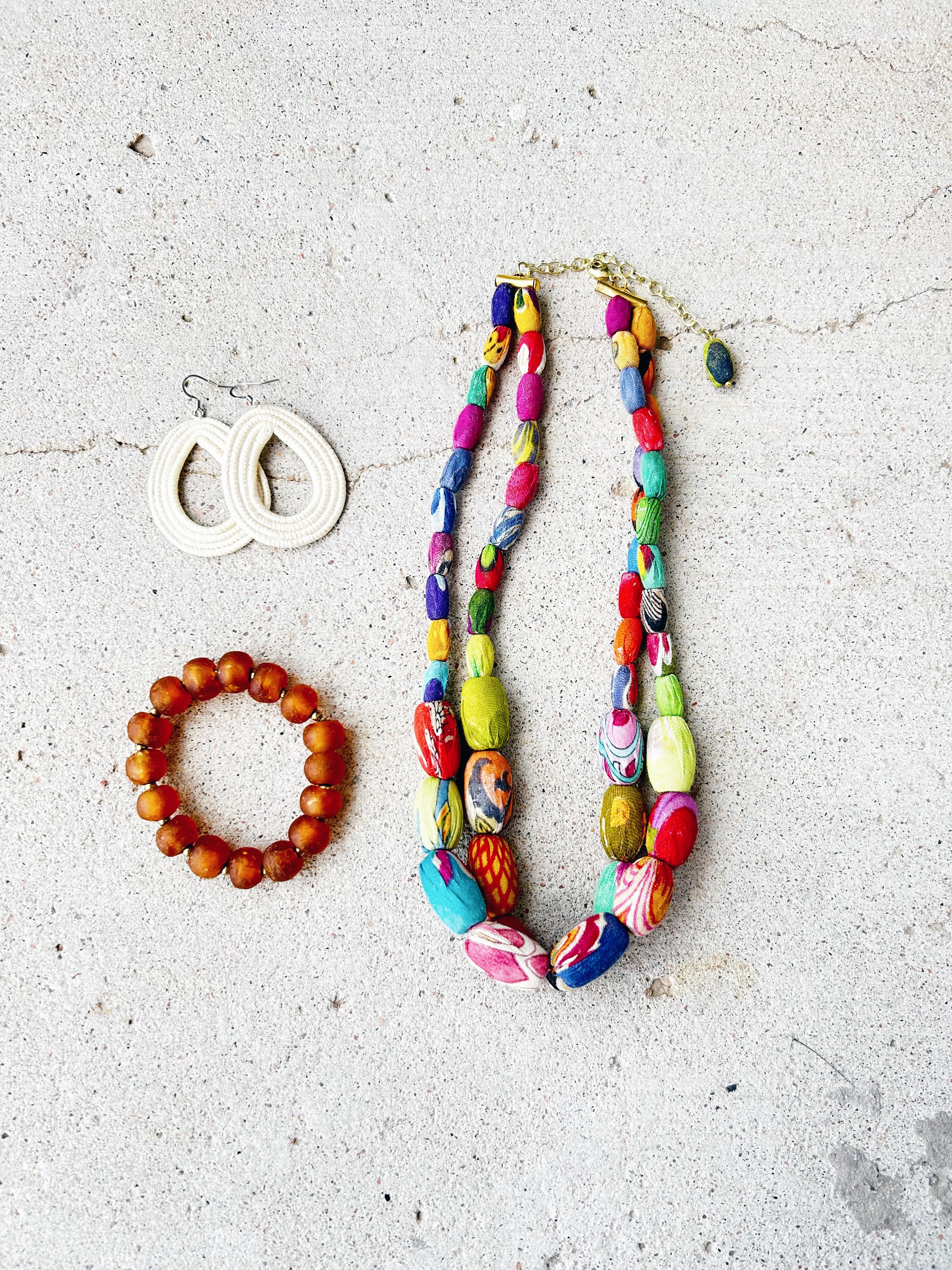 The Elliptical Layers Kantha Necklace is shown with the Loop Earrings and Burnt Orange Unity Bracelet.