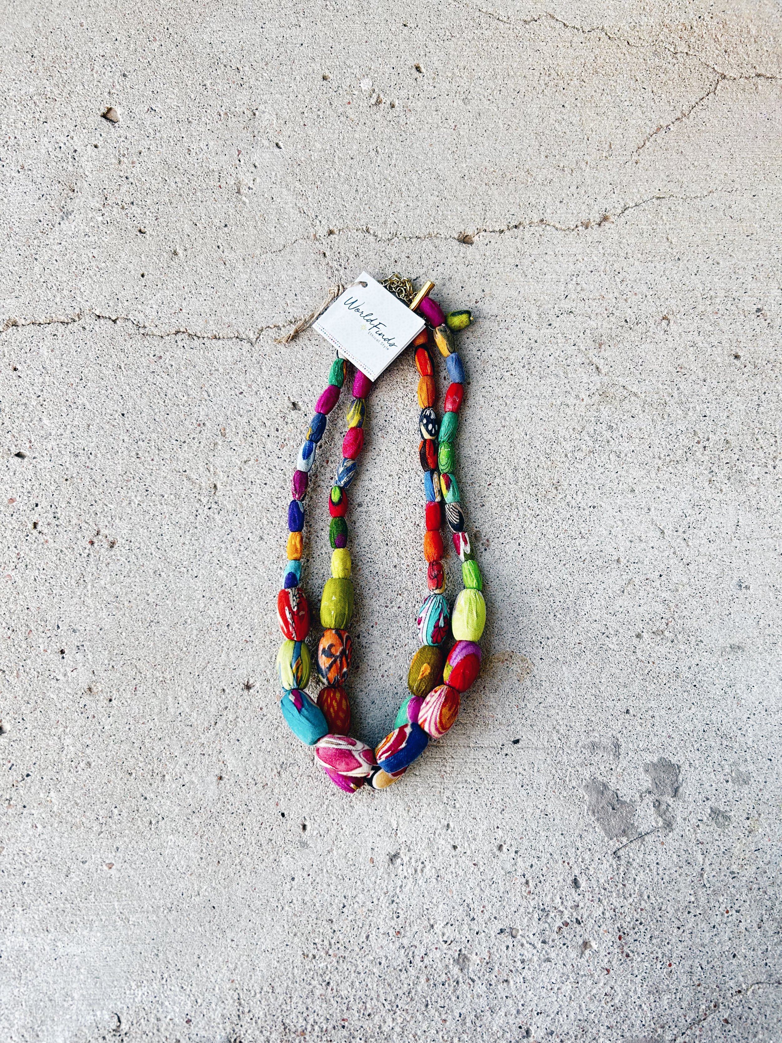 The Elliptical Layers Kantha Necklace is shown with its original World Finds tags.