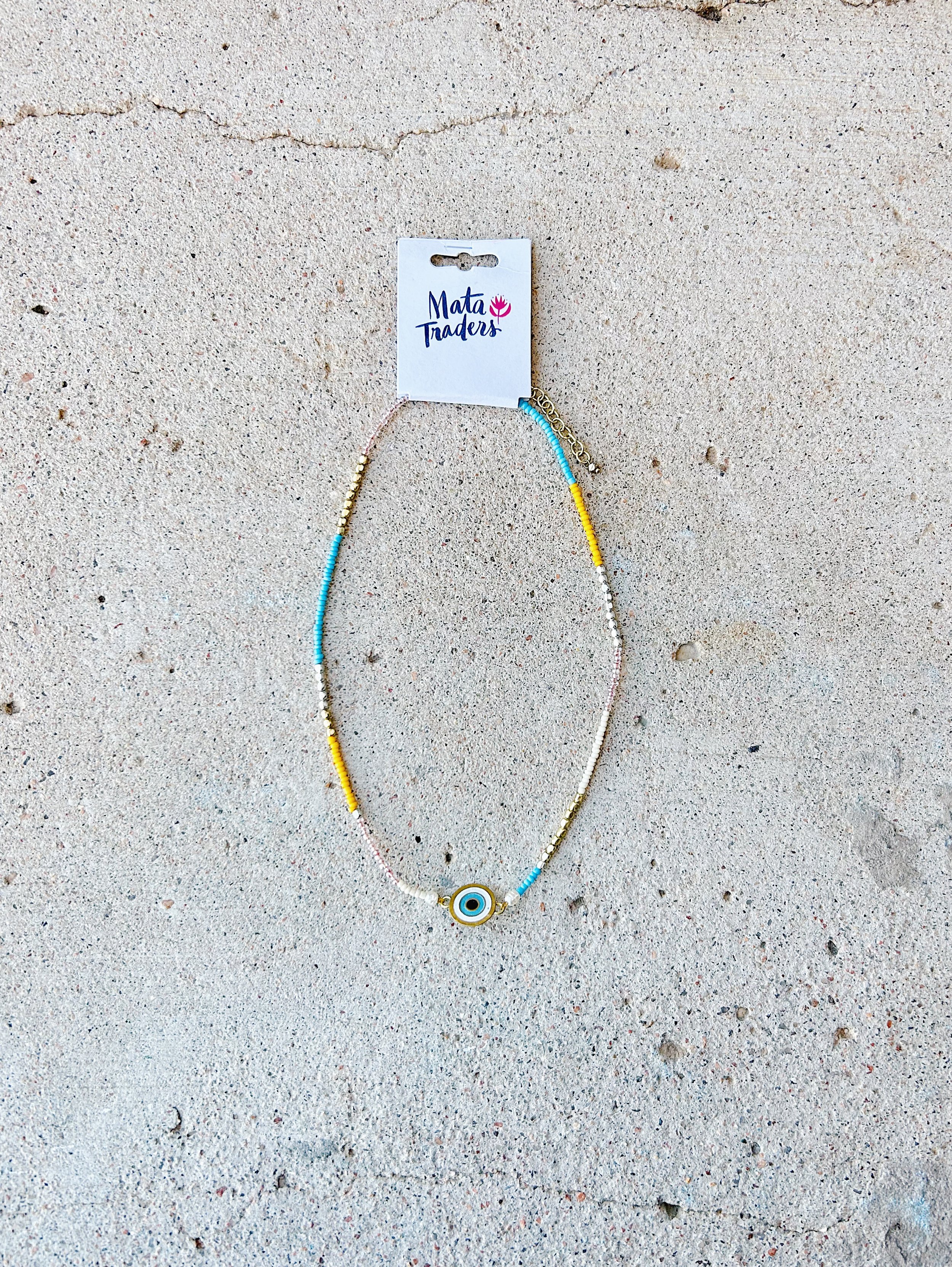 The Double Vision Necklace is shown with its original Mata Traders packaging.