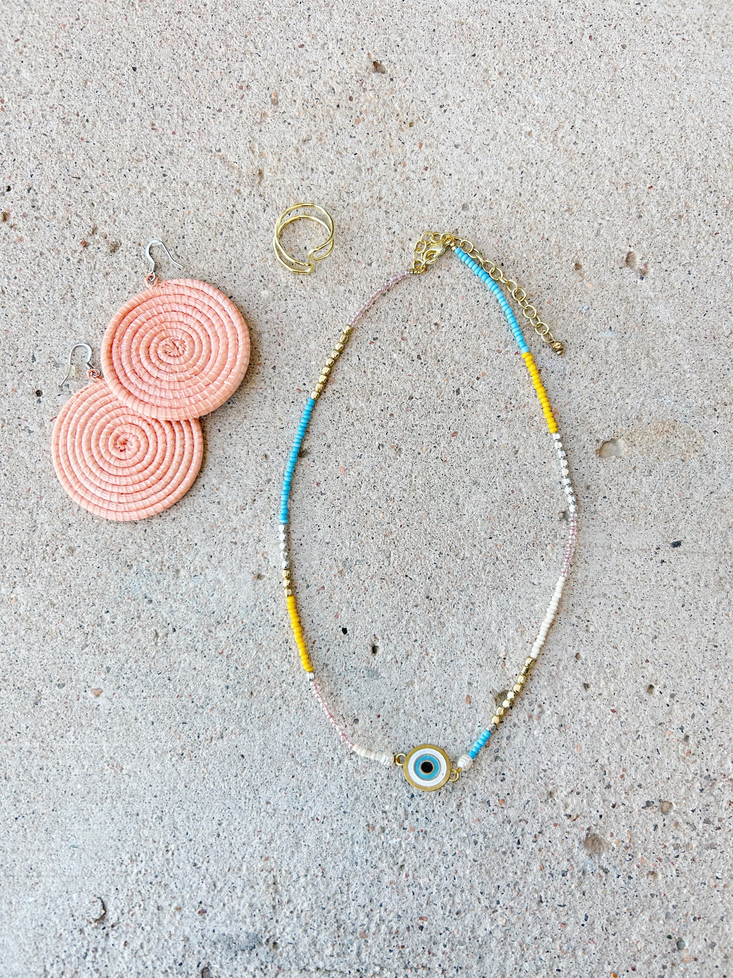 The Double Vision Necklace matches well with the Large Disc Earrings in blush and the Illusion Ring in gold.